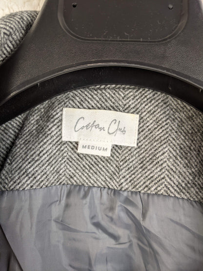 Close-up of Cotton Club label on grey herringbone vest