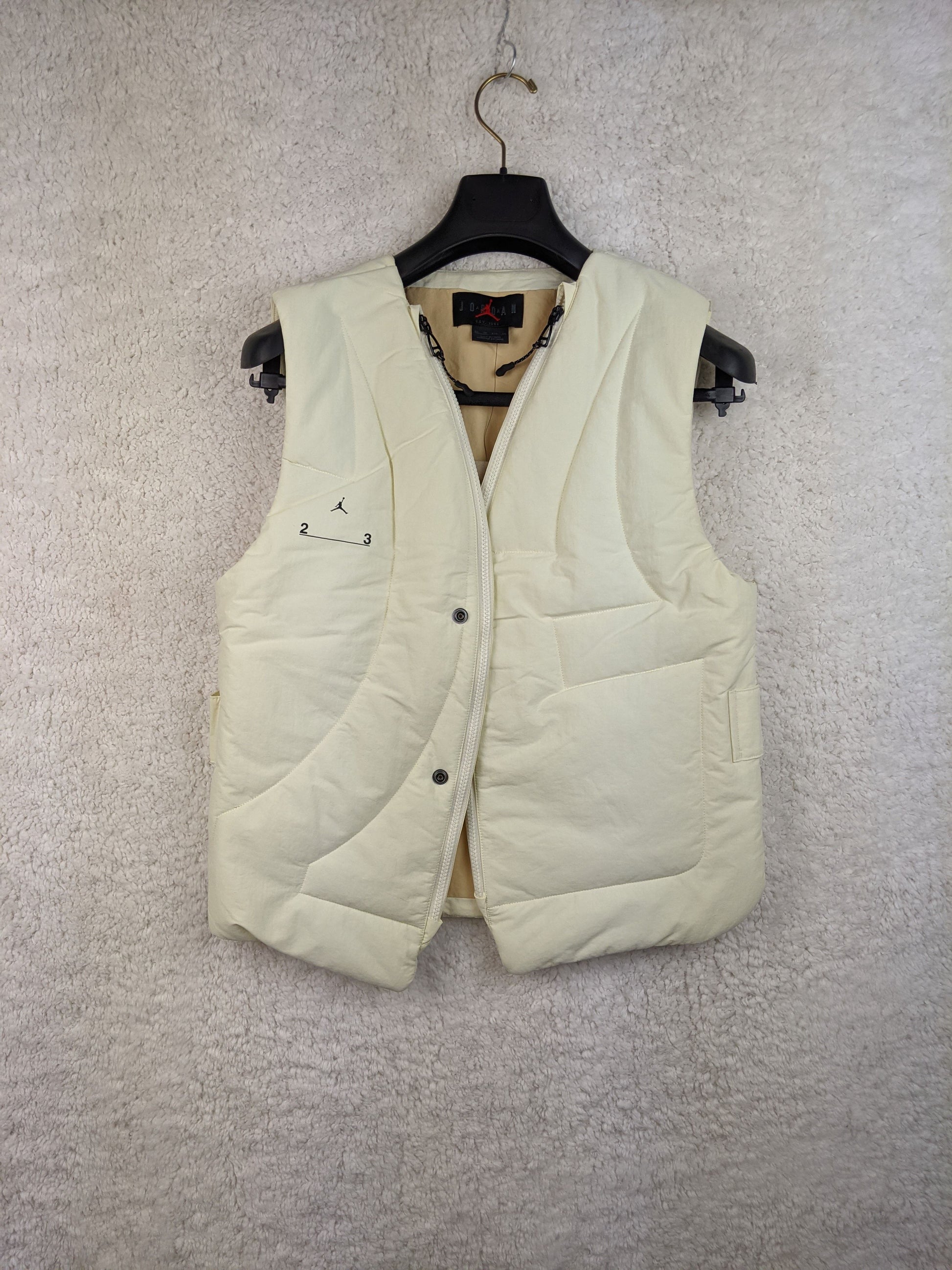 Front view of cream Jordan padded vest