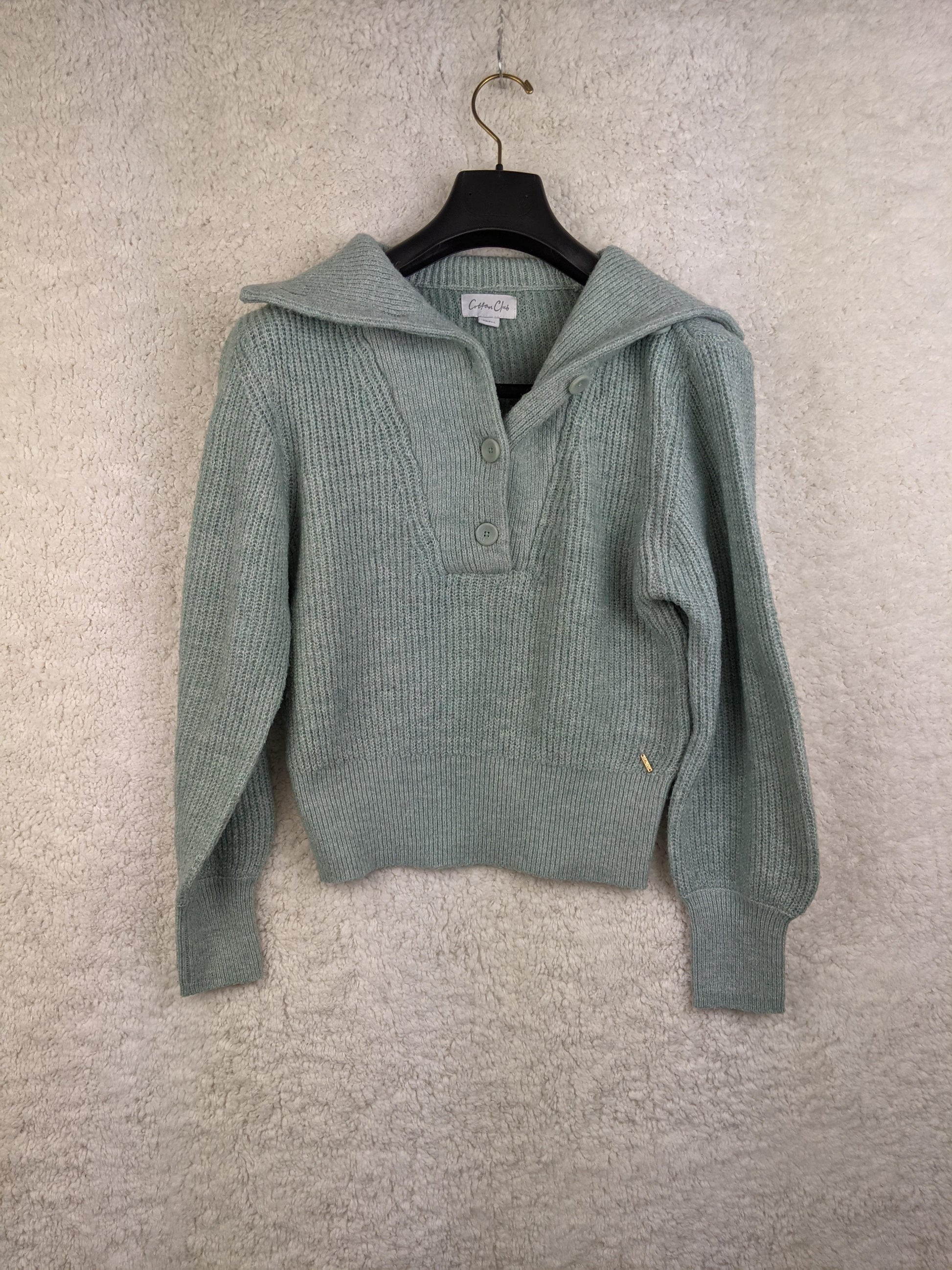 Front view of light green ribbed sweater