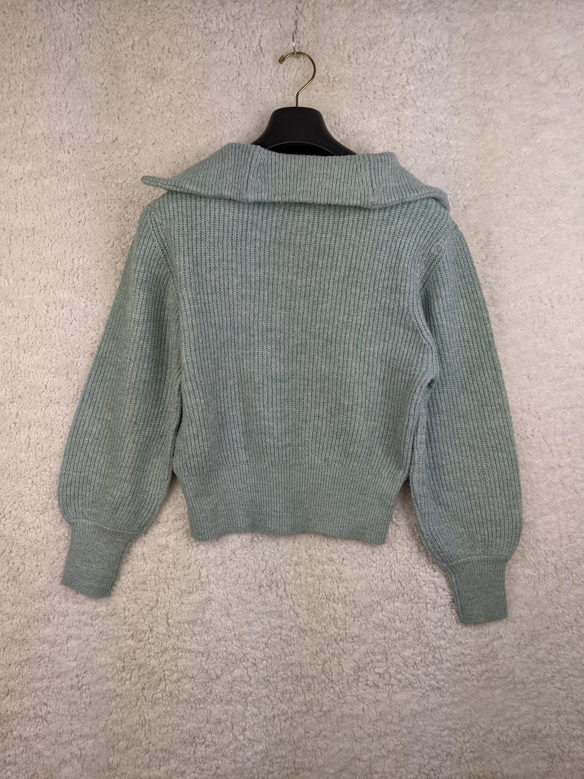 Back view of light green ribbed sweater