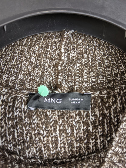 Close-up of MNG label on brown knit sweater