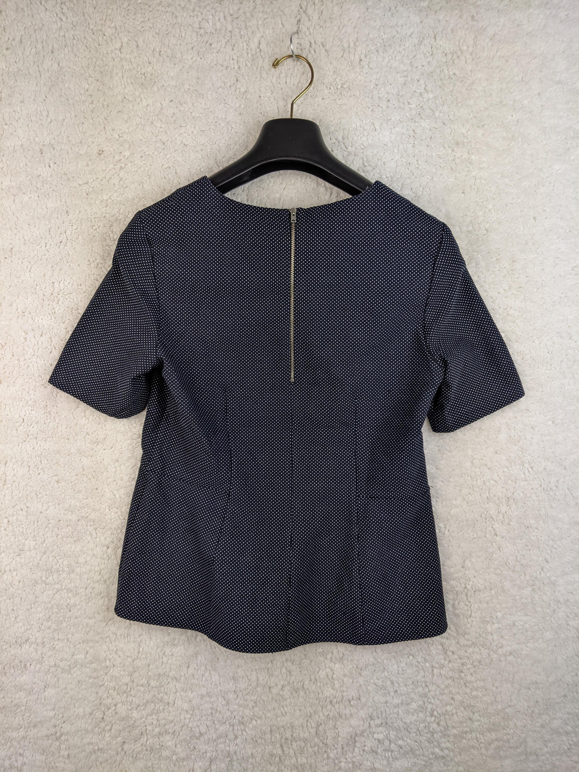 Navy polka dot blouse back view