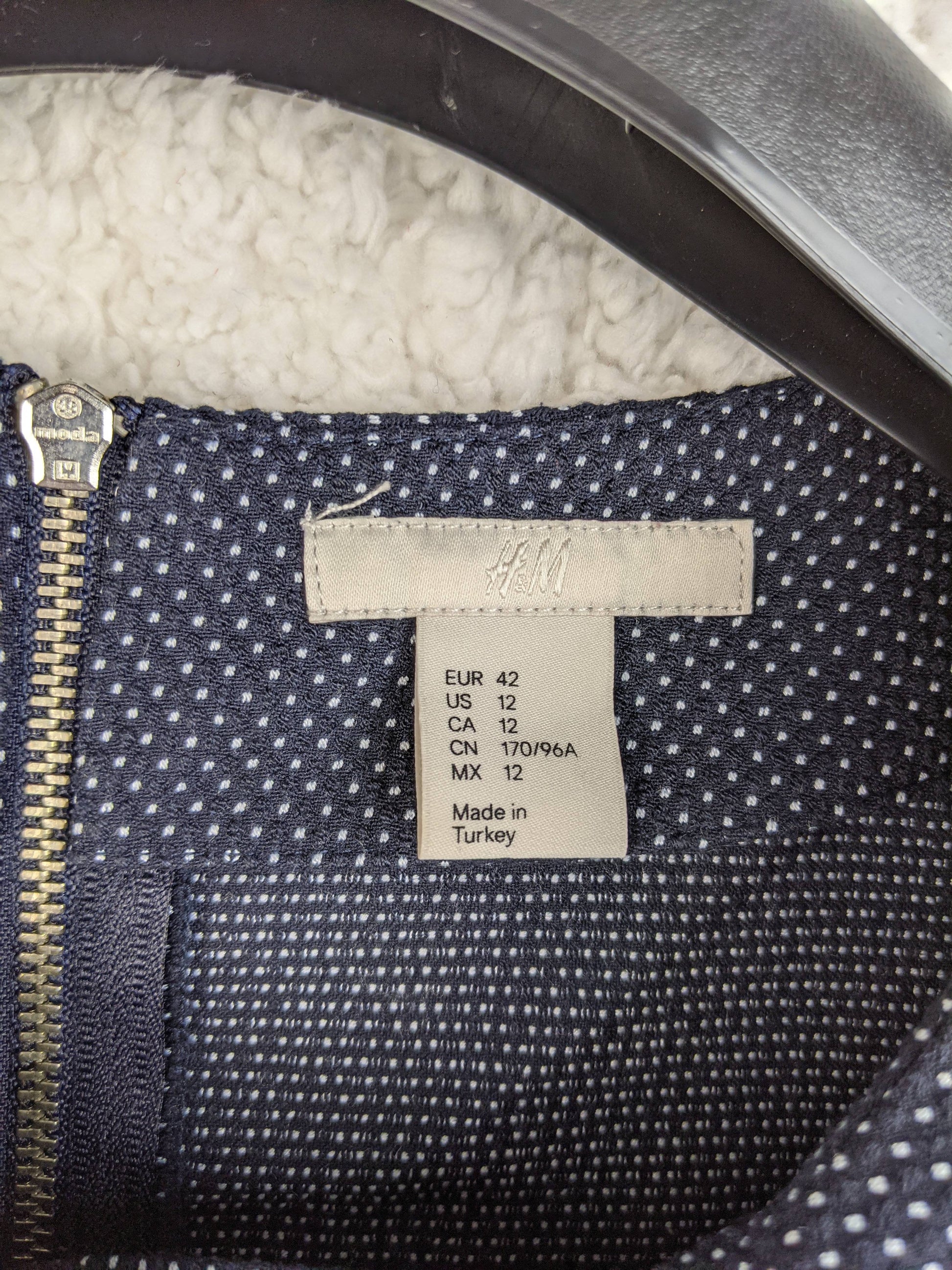 Size tag of navy polka dot blouse