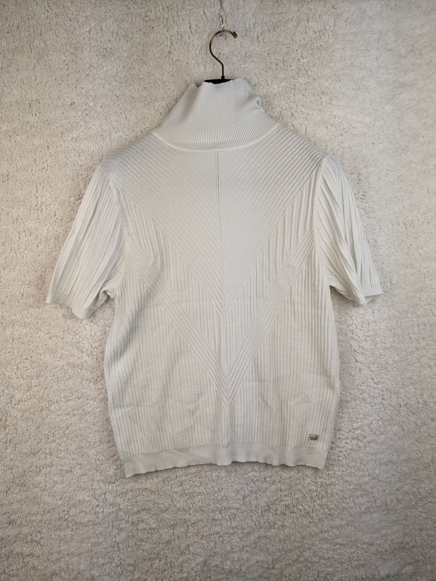 Front view of white ribbed turtleneck sweater