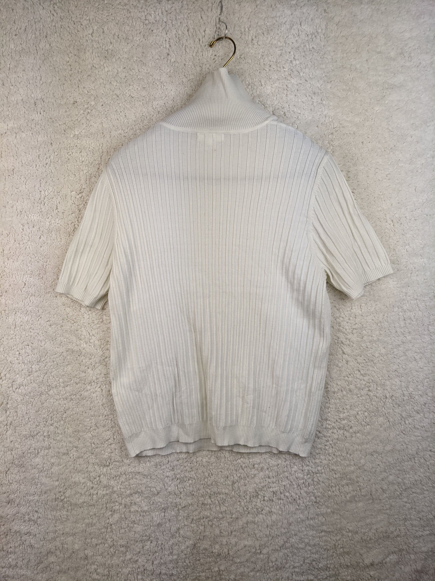 Back view of white ribbed turtleneck sweater