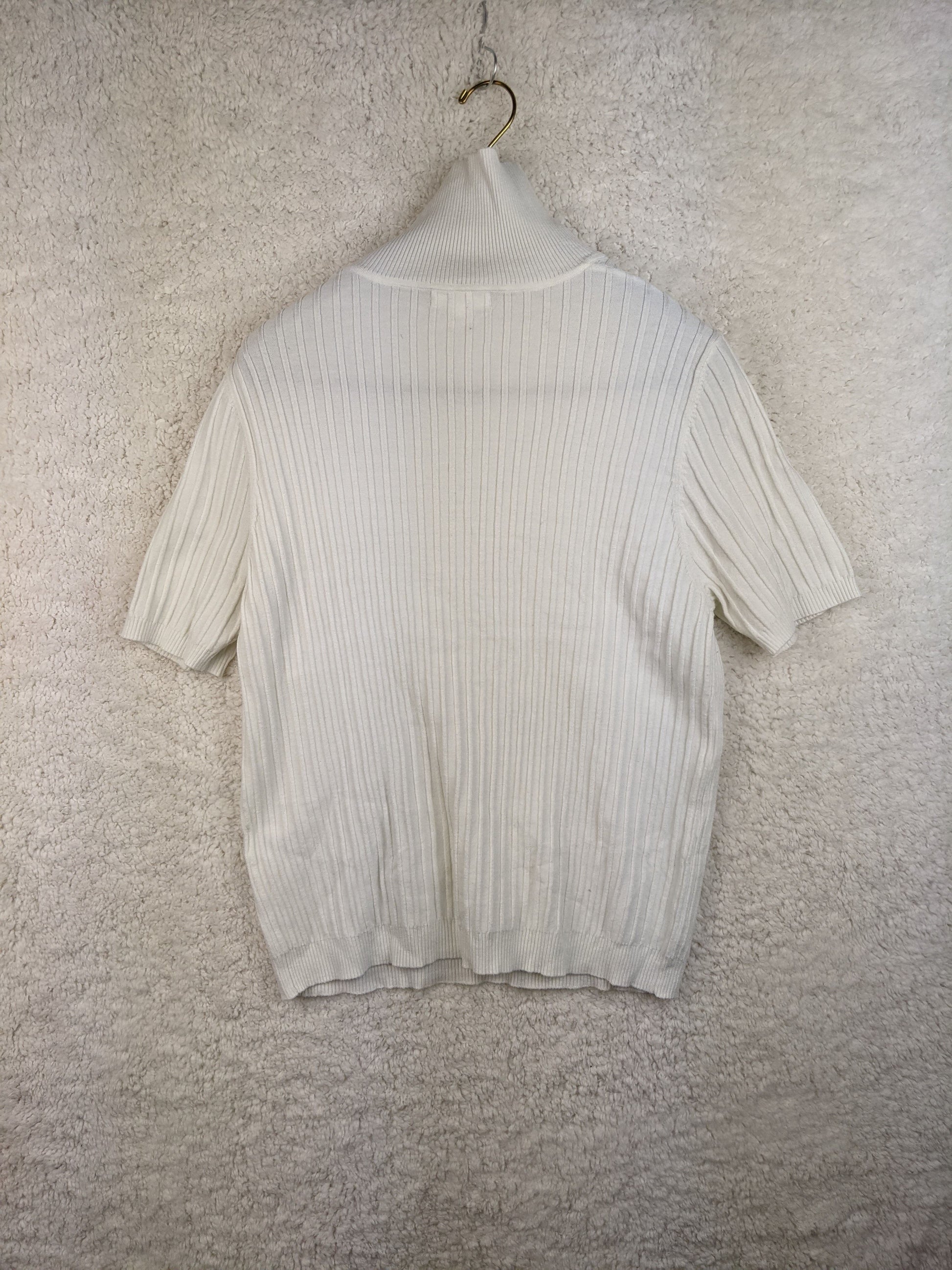 Back view of white ribbed turtleneck sweater