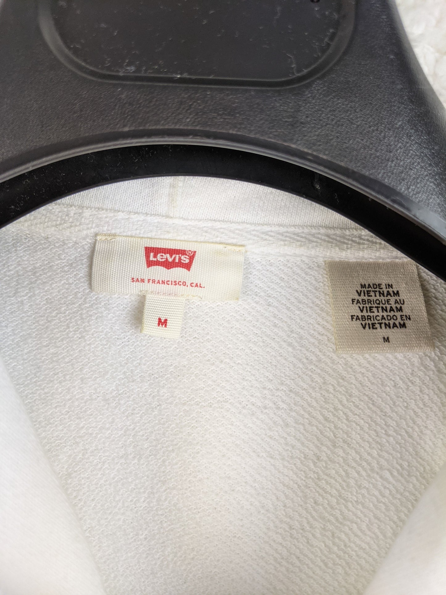 Close-up of Levi's hoodie label showing size M