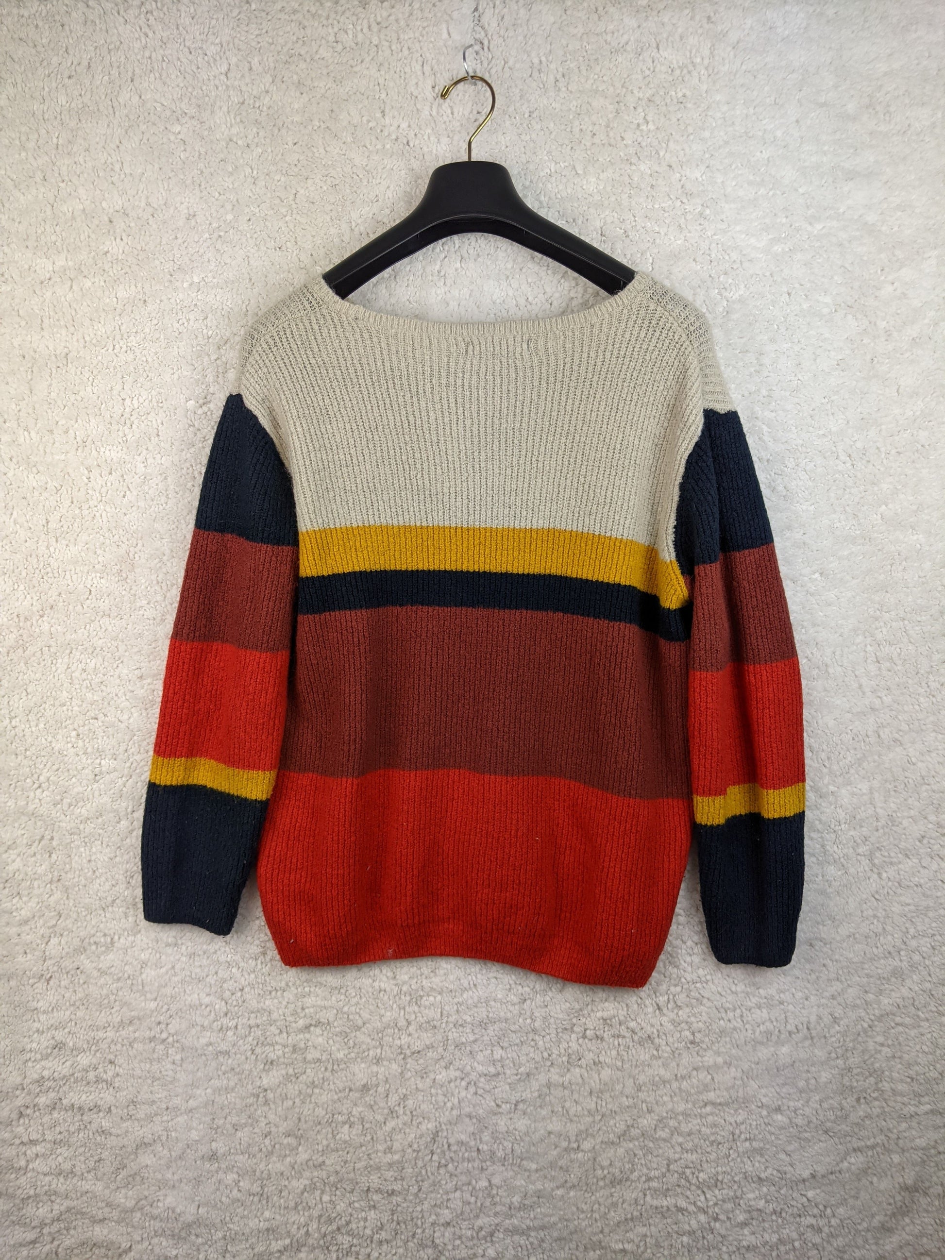 Back view of multicolor striped sweater on hanger