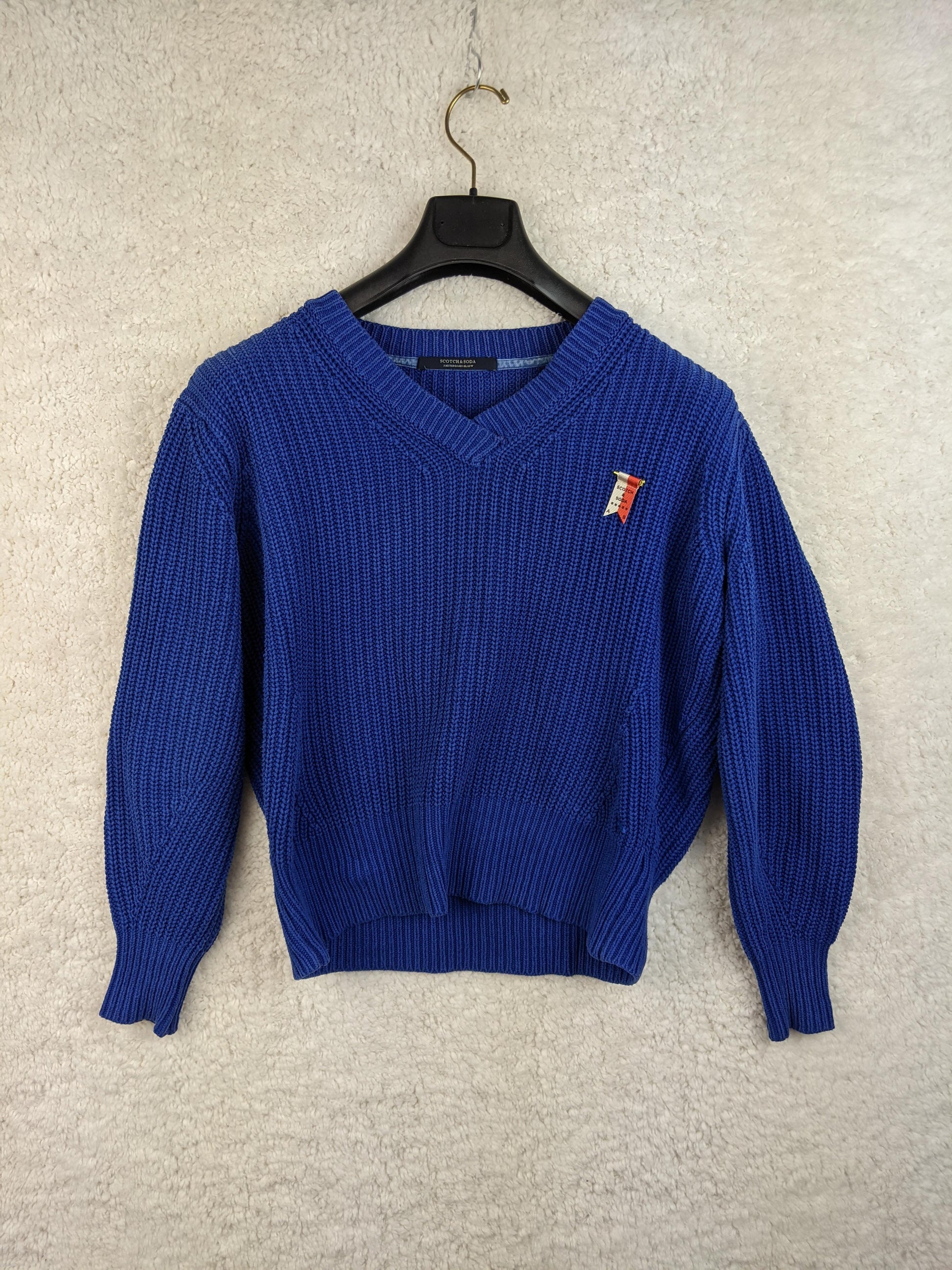 Blue knit sweater on hanger