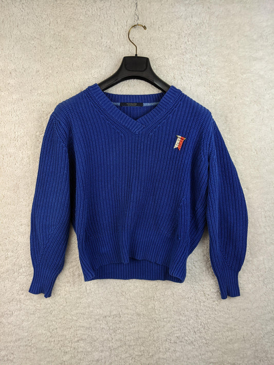 Blue knit sweater on hanger