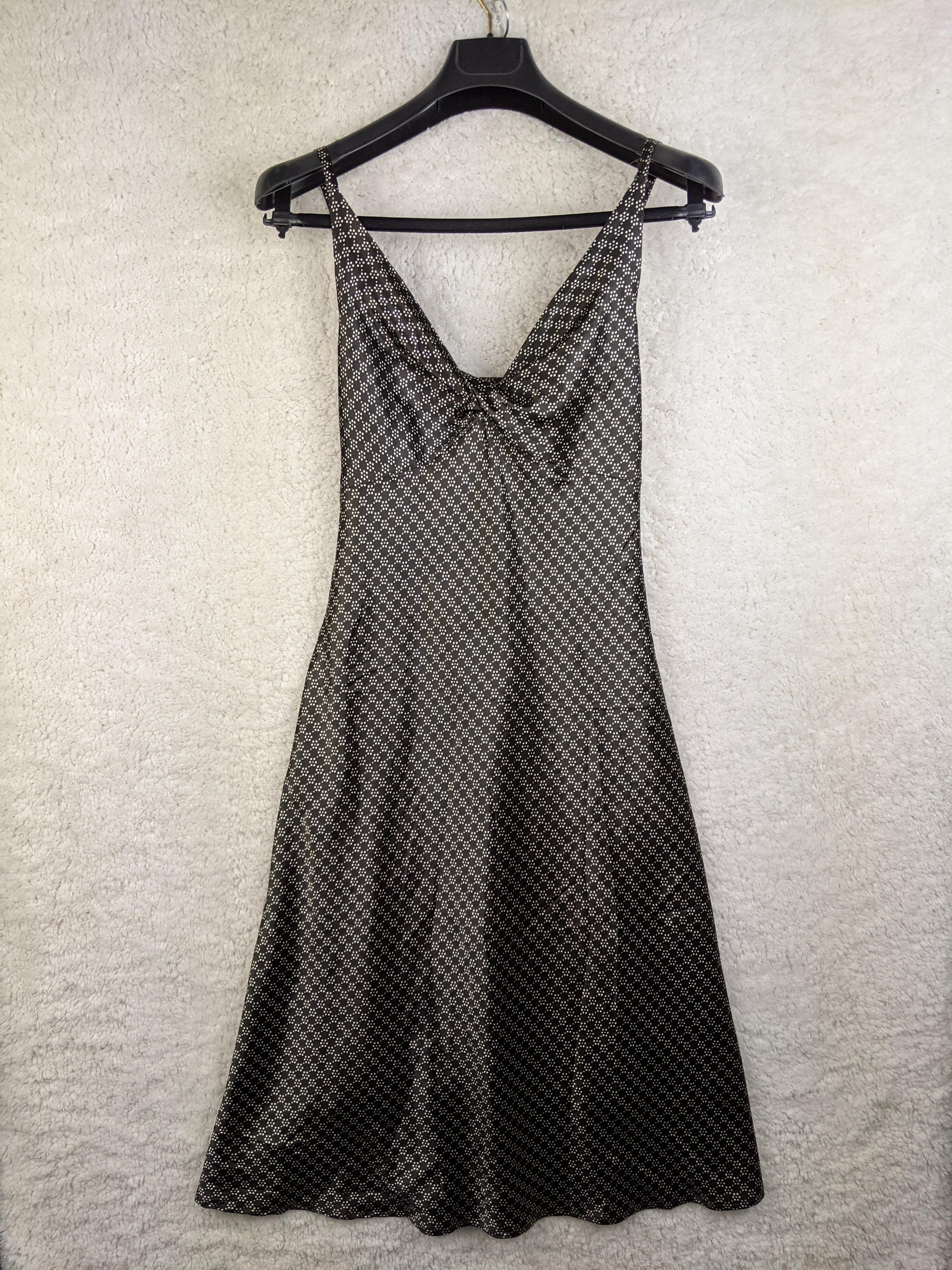 Savannah black and gray patterned dress hanging on a hanger