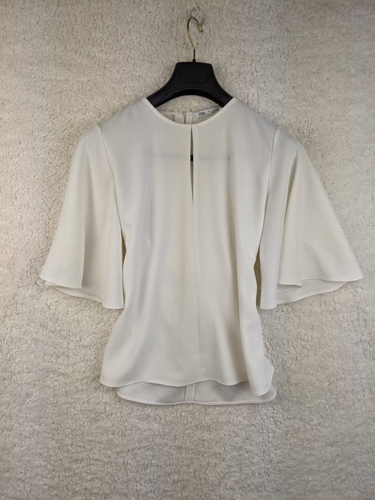 Front view of white Zara blouse with tie back