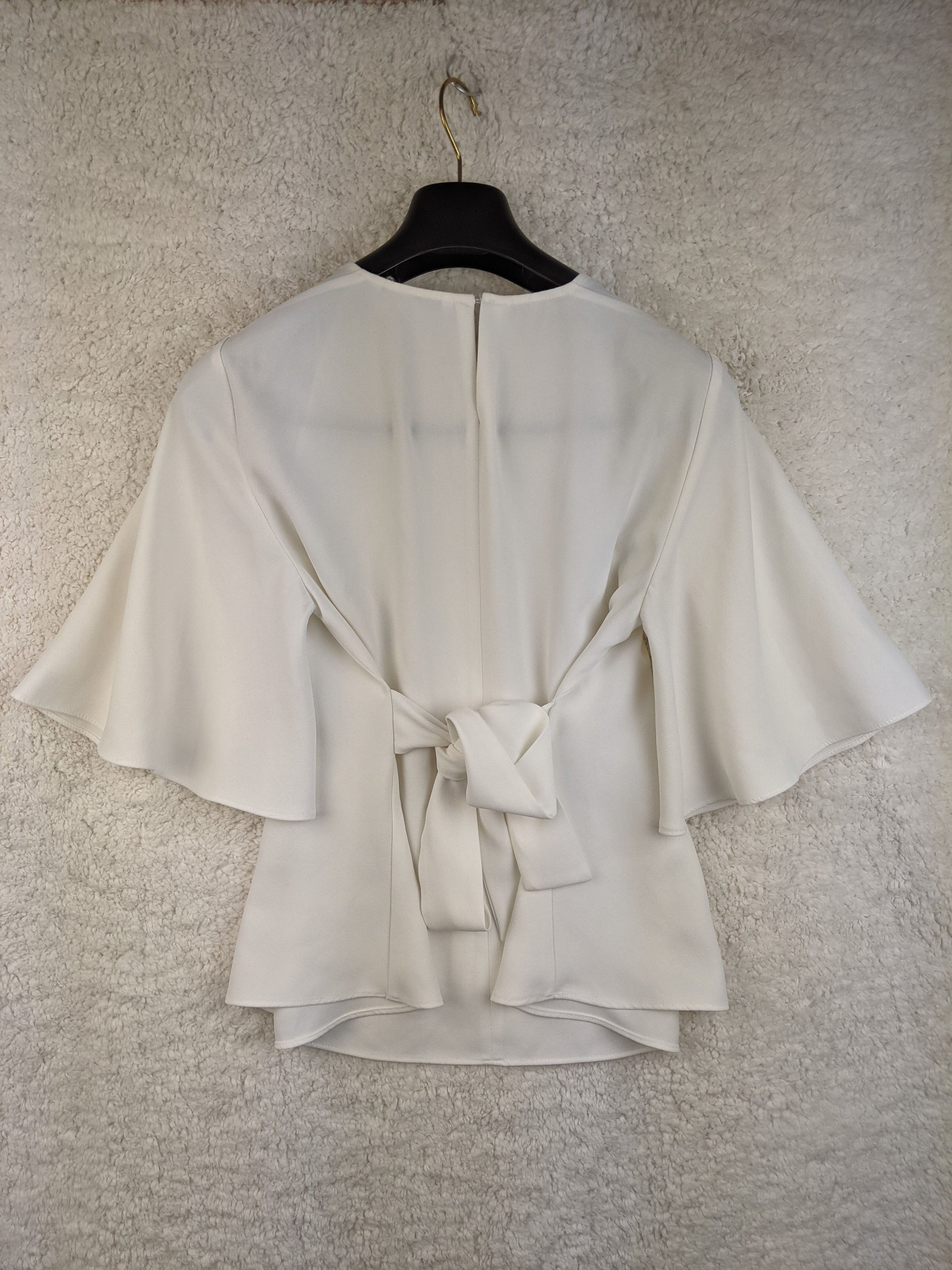 Rear view of white Zara blouse showing tie detail