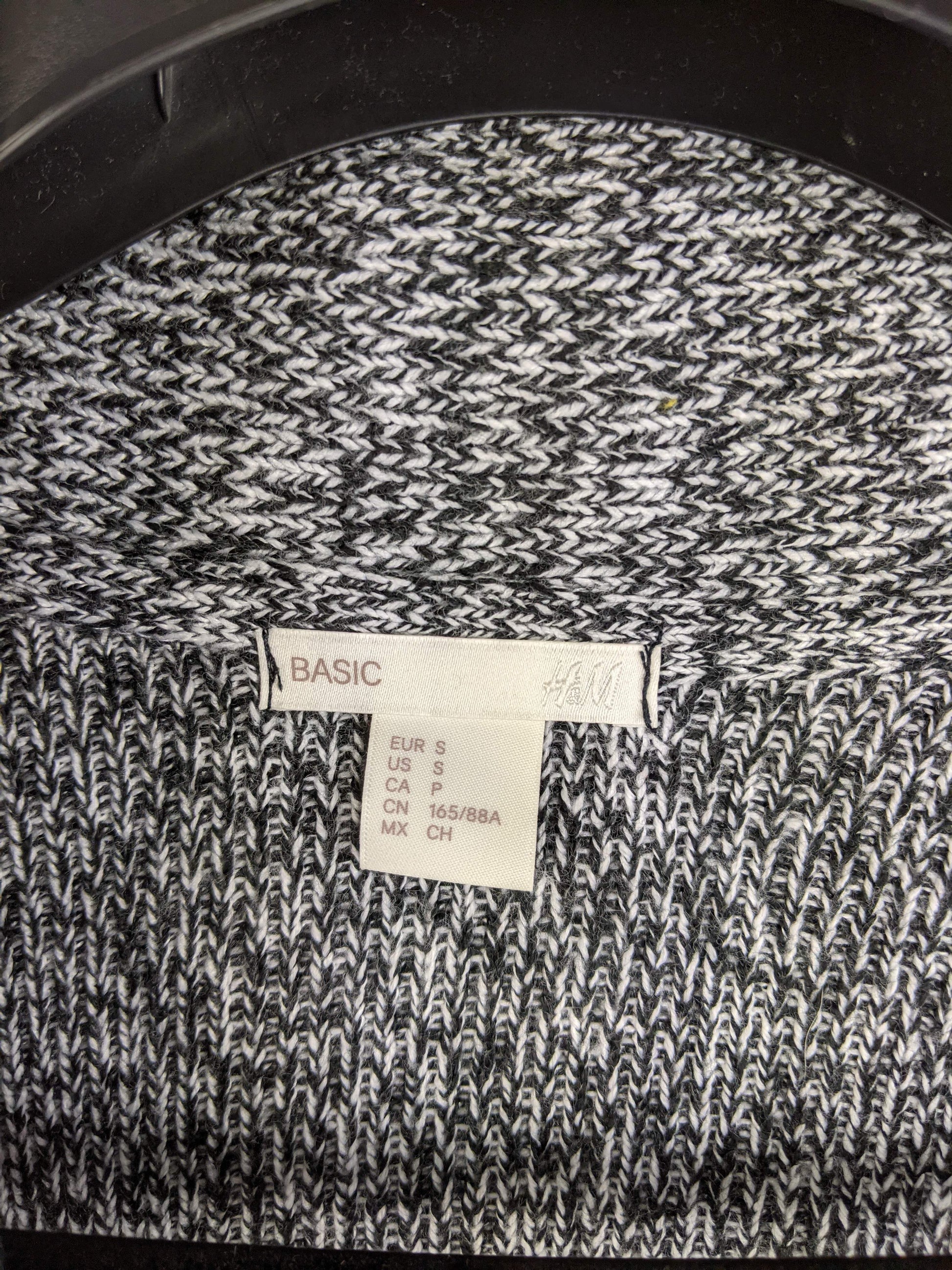 Close-up of H&M label showing size and brand