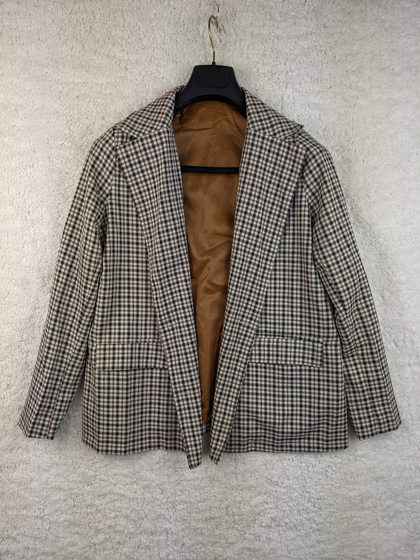 Front view of vintage plaid blazer on hanger