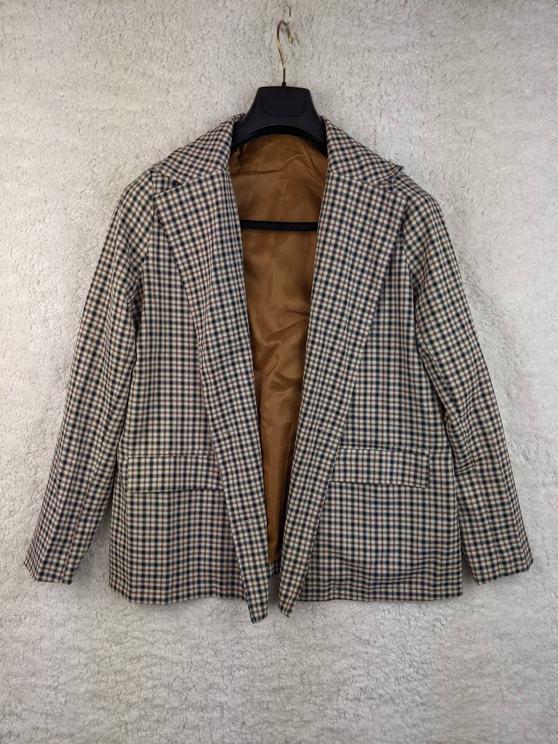 Front view of vintage plaid blazer on hanger