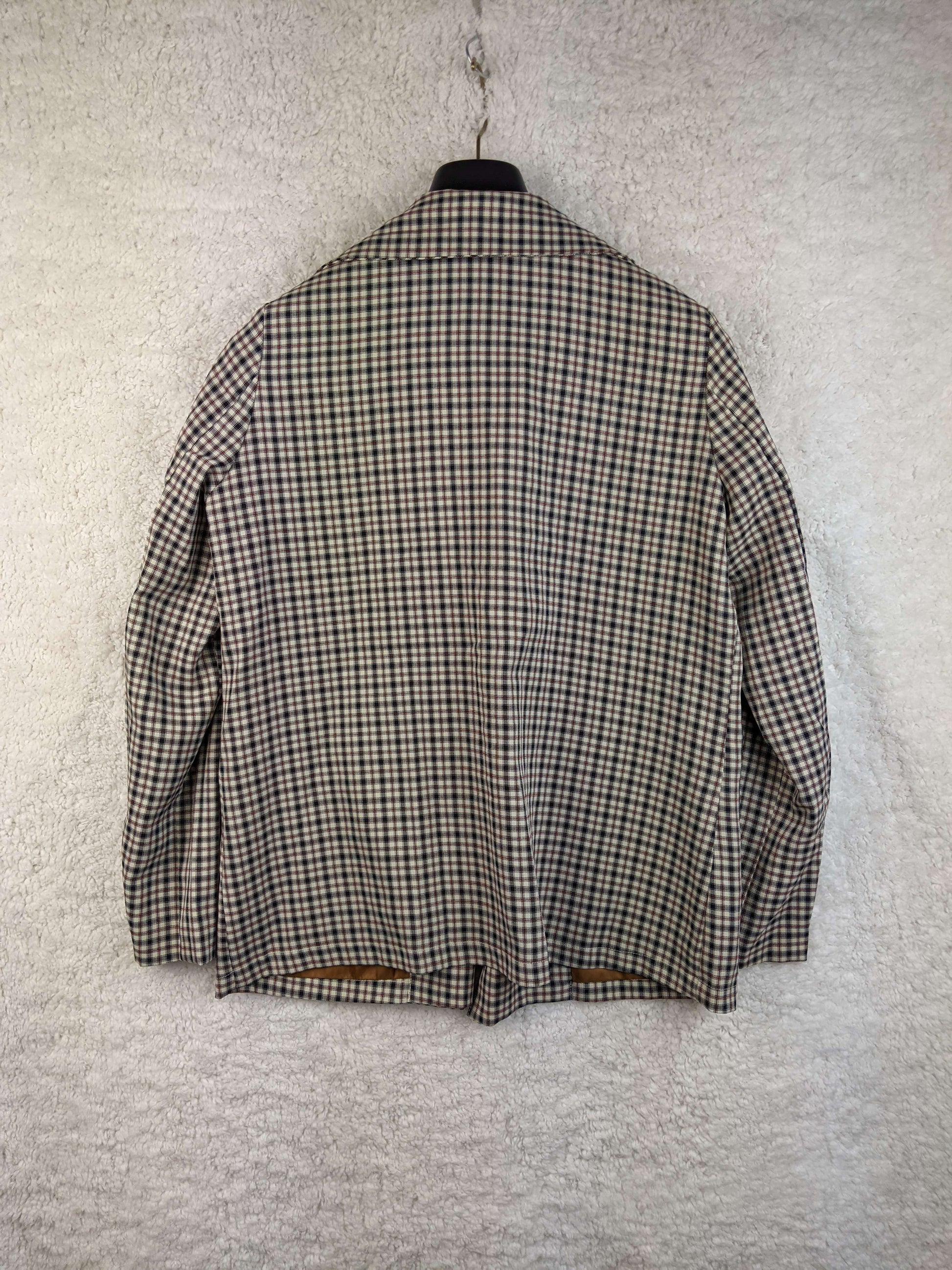 Back view of vintage plaid blazer on hanger