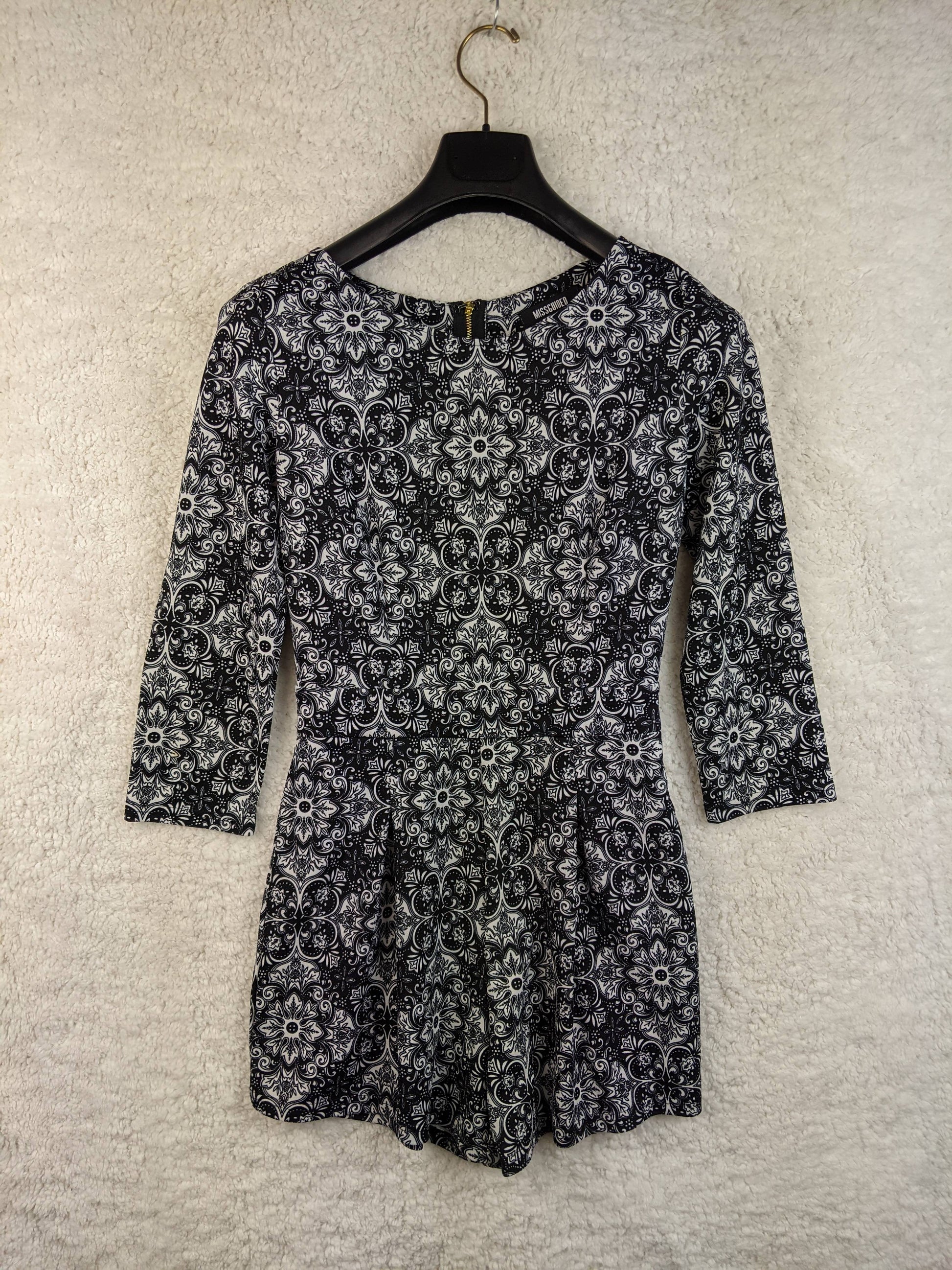 Front view of black and white patterned romper