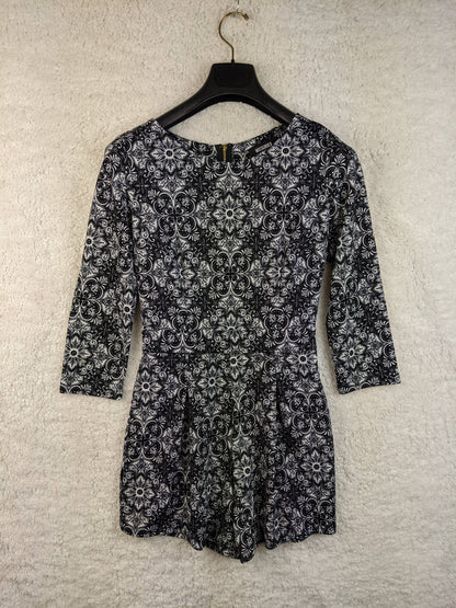Front view of black and white patterned romper