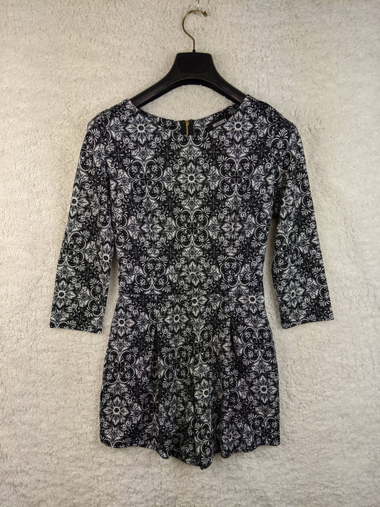 Front view of black and white patterned romper