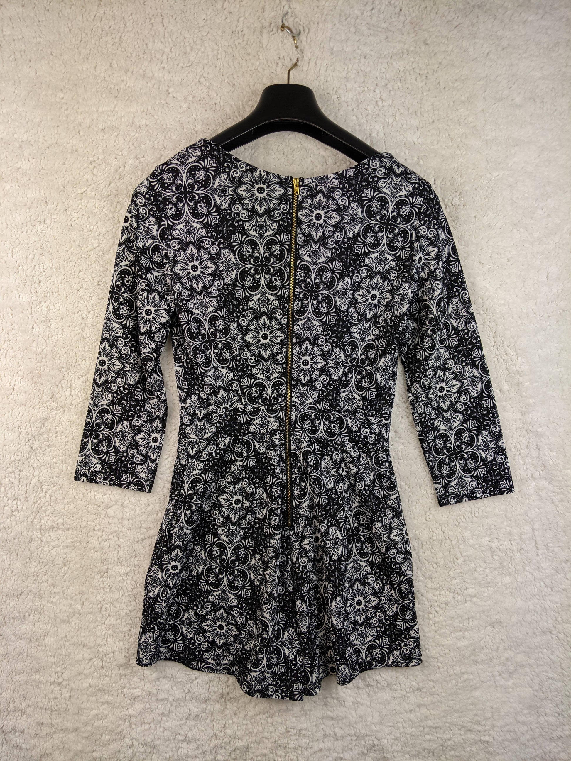 Back view of black and white patterned romper