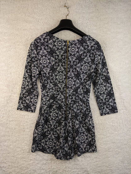 Back view of black and white patterned romper