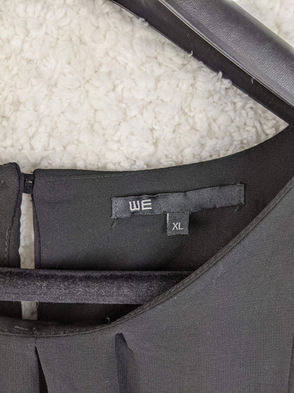 Close-up of WE brand label and size on dress