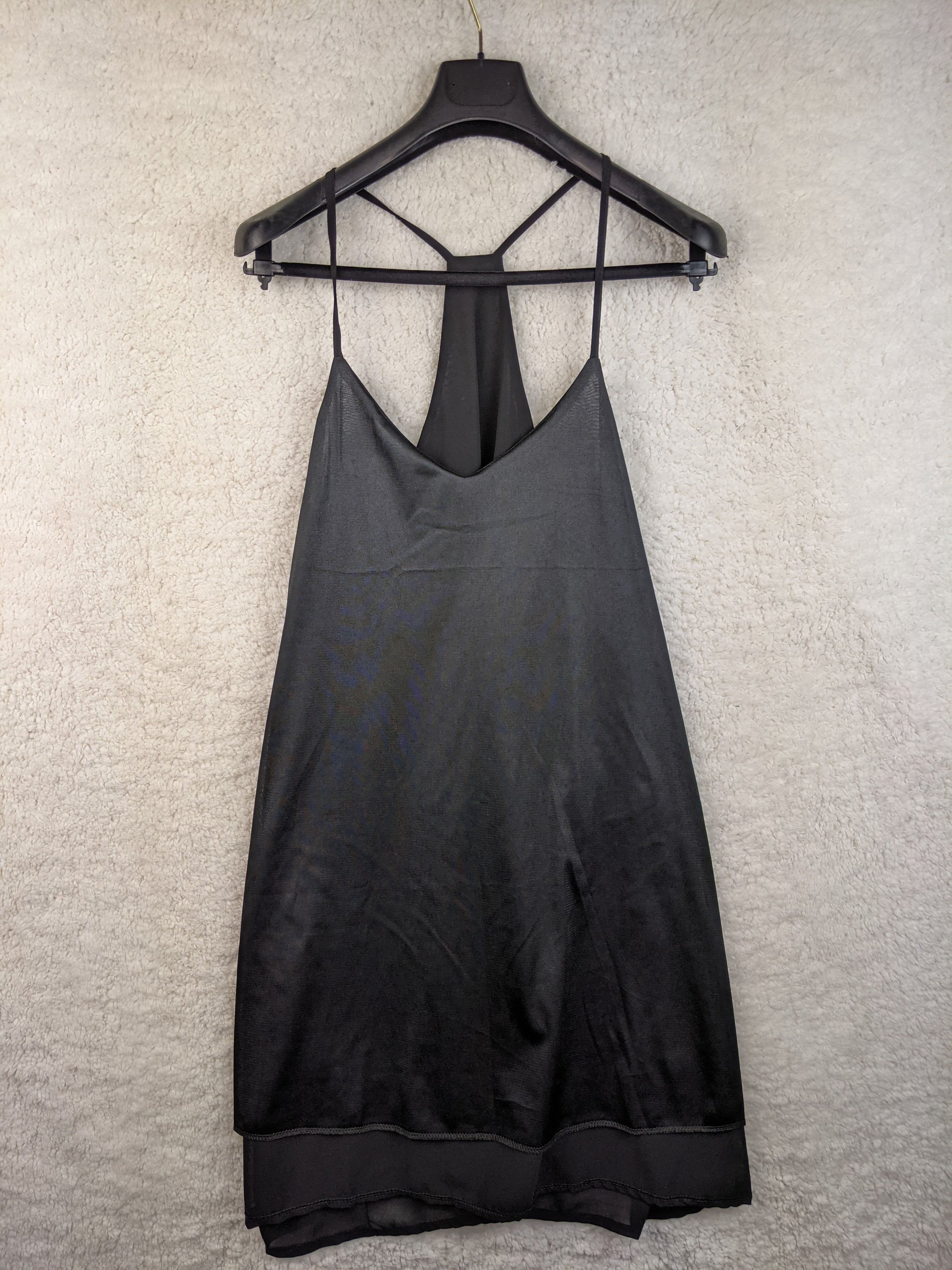 Front view of black slip dress on hanger
