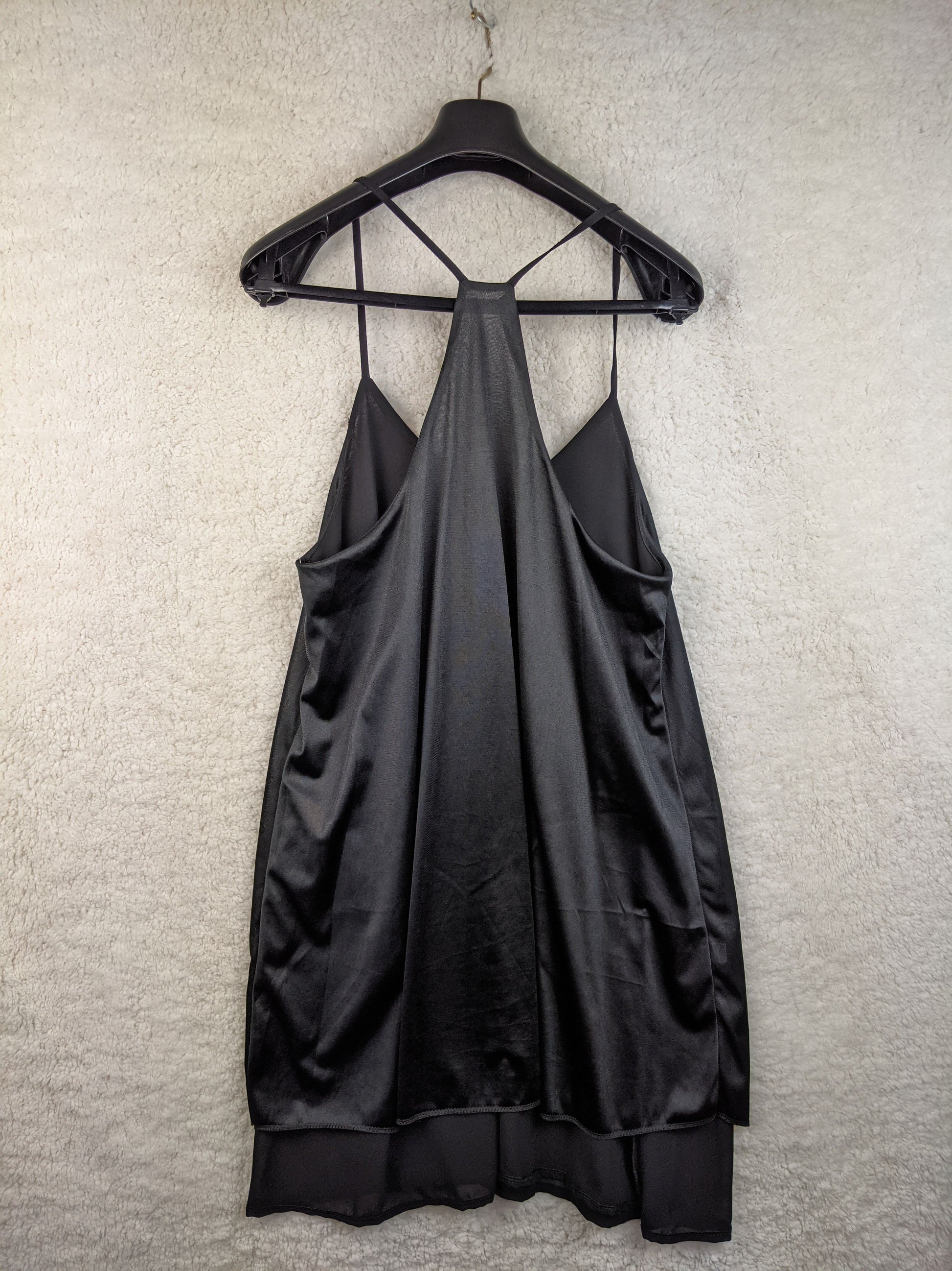 Back view of black slip dress on hanger
