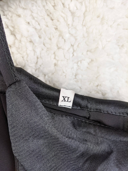 Size tag showing XL on black slip dress