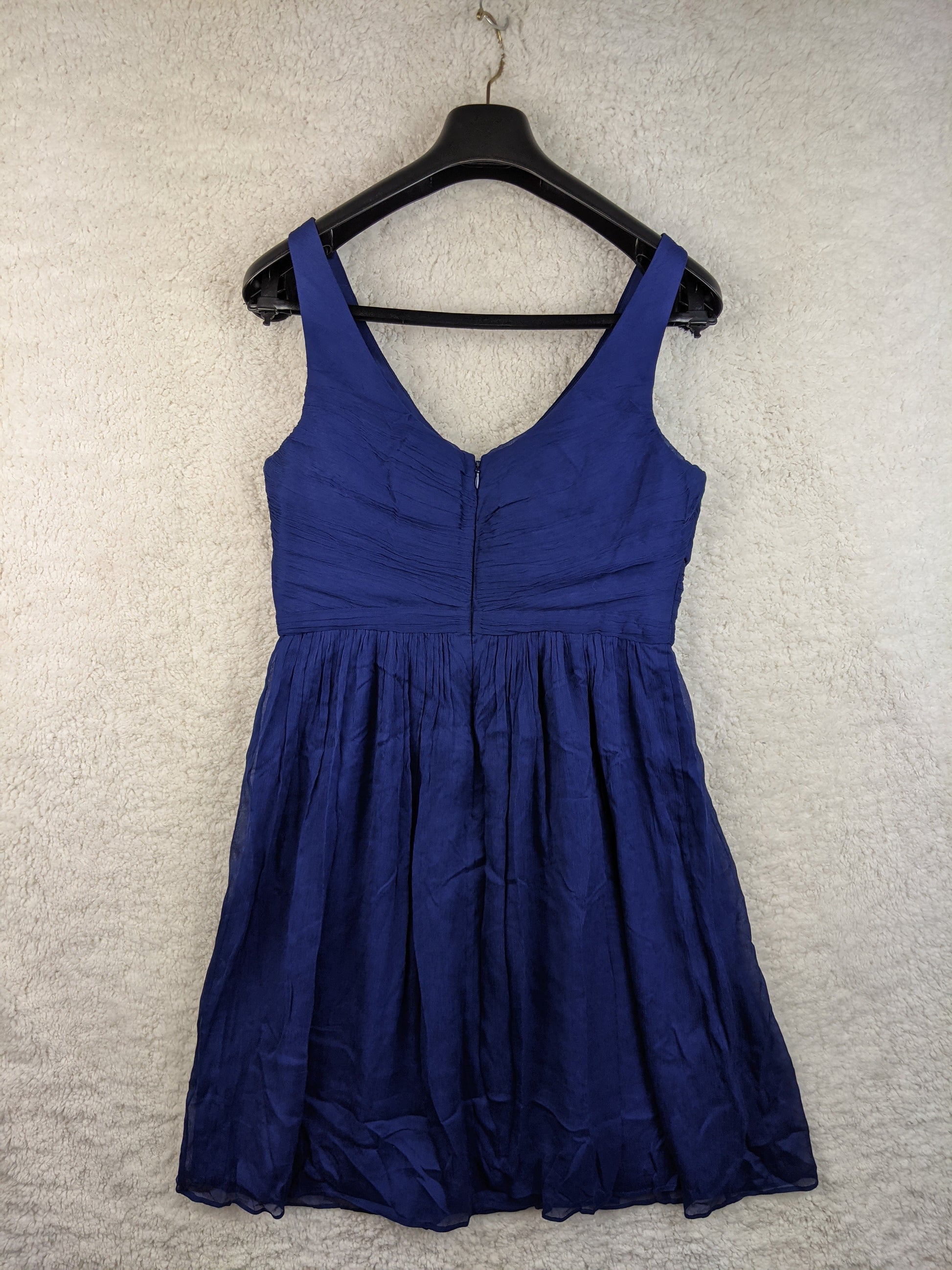 Back view of a blue sleeveless dress on hanger