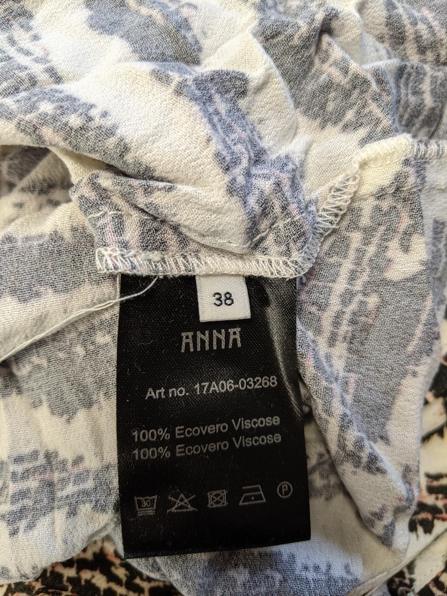 Close-up of size and material tag showing size 38