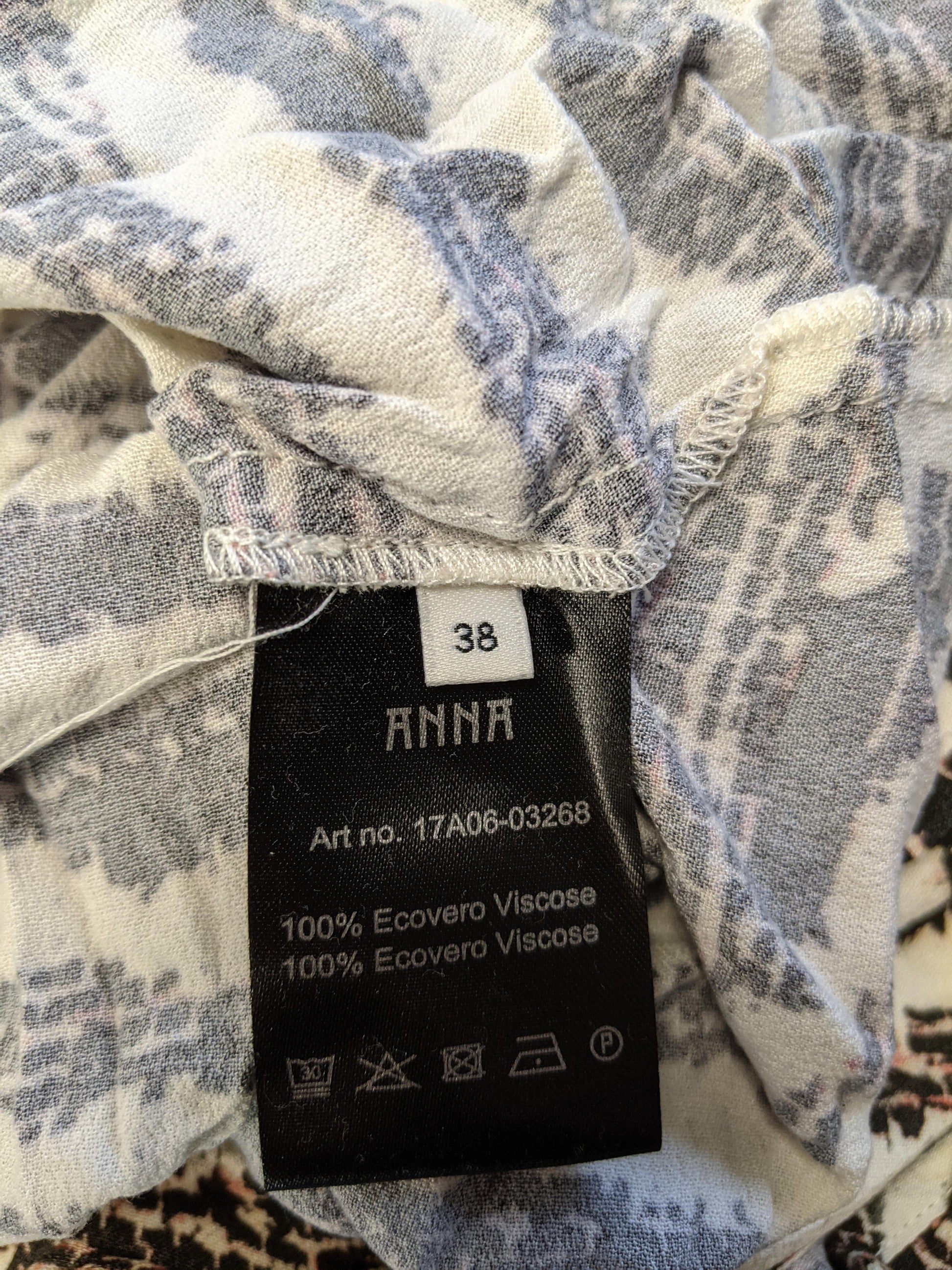 Close-up of size and material tag showing size 38