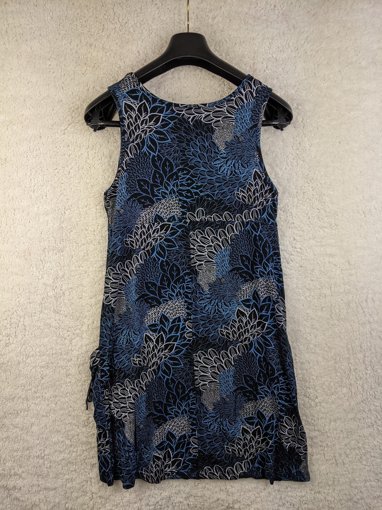 Back view of blue floral sleeveless dress