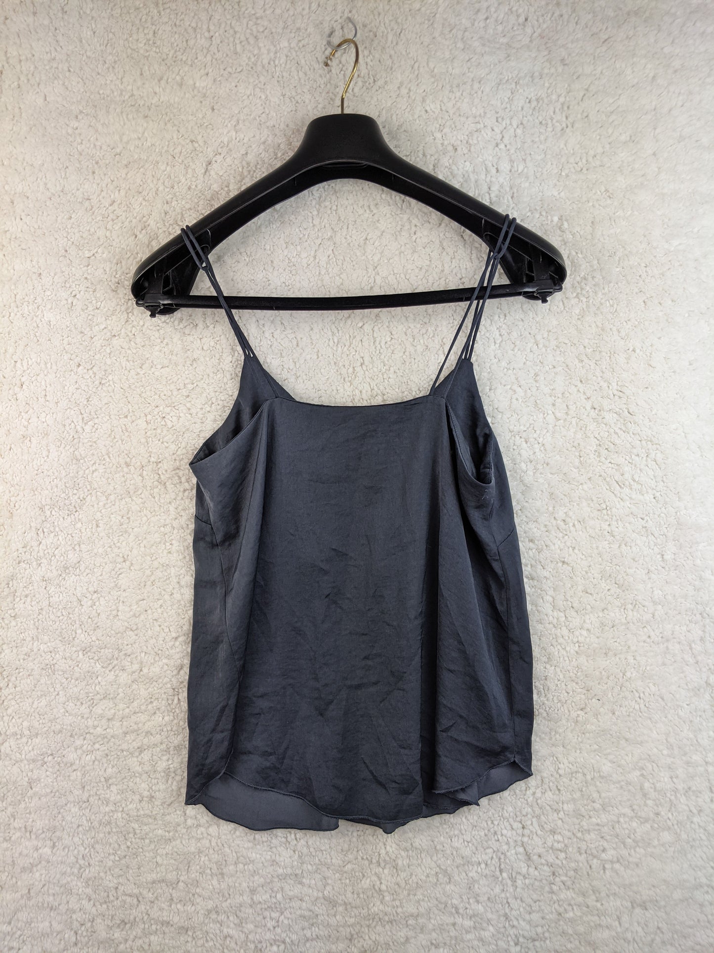 Black spaghetti strap top on hanger, back view