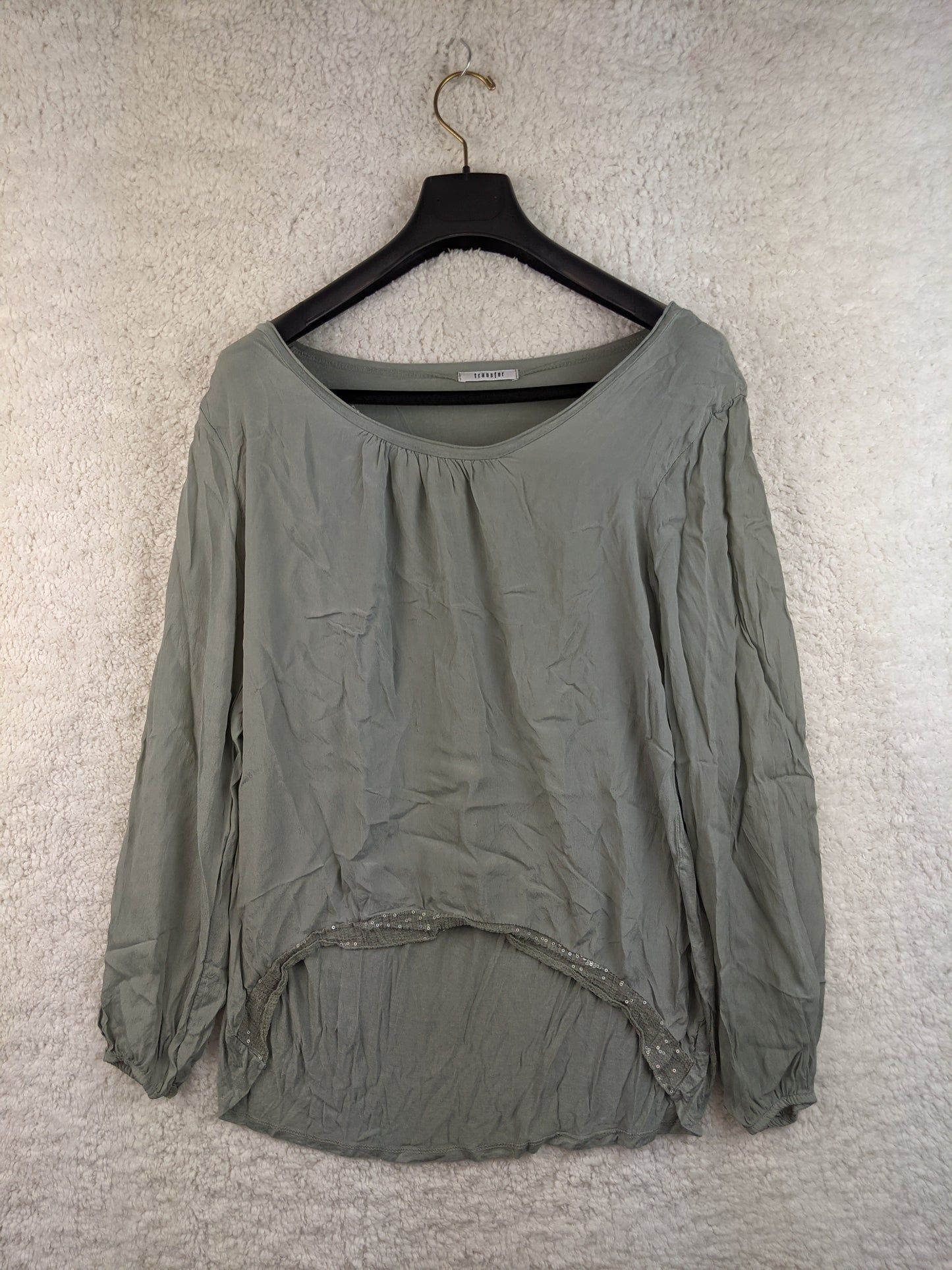 Front view of sage green blouse on hanger