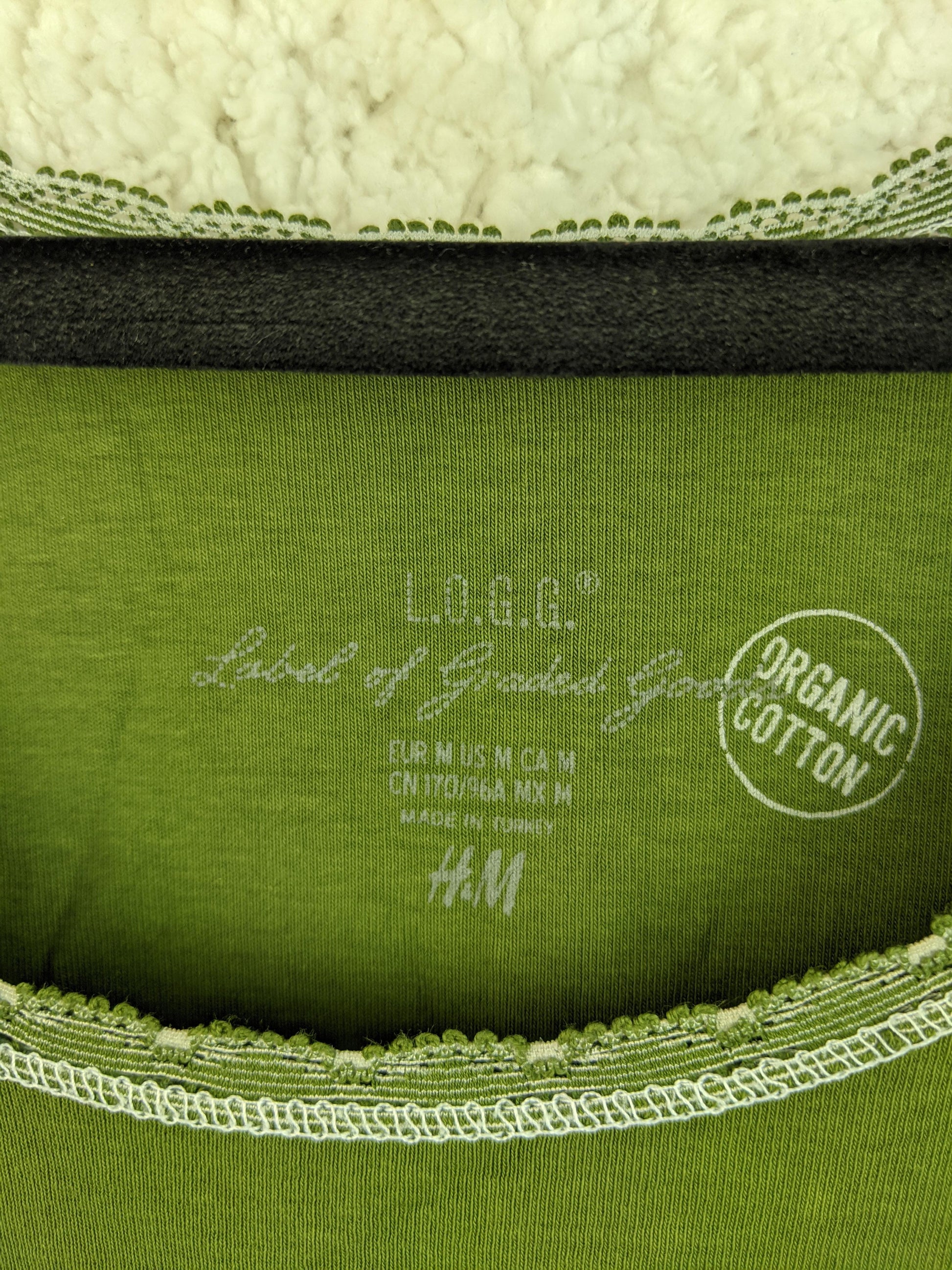 Close-up of label on green tank top