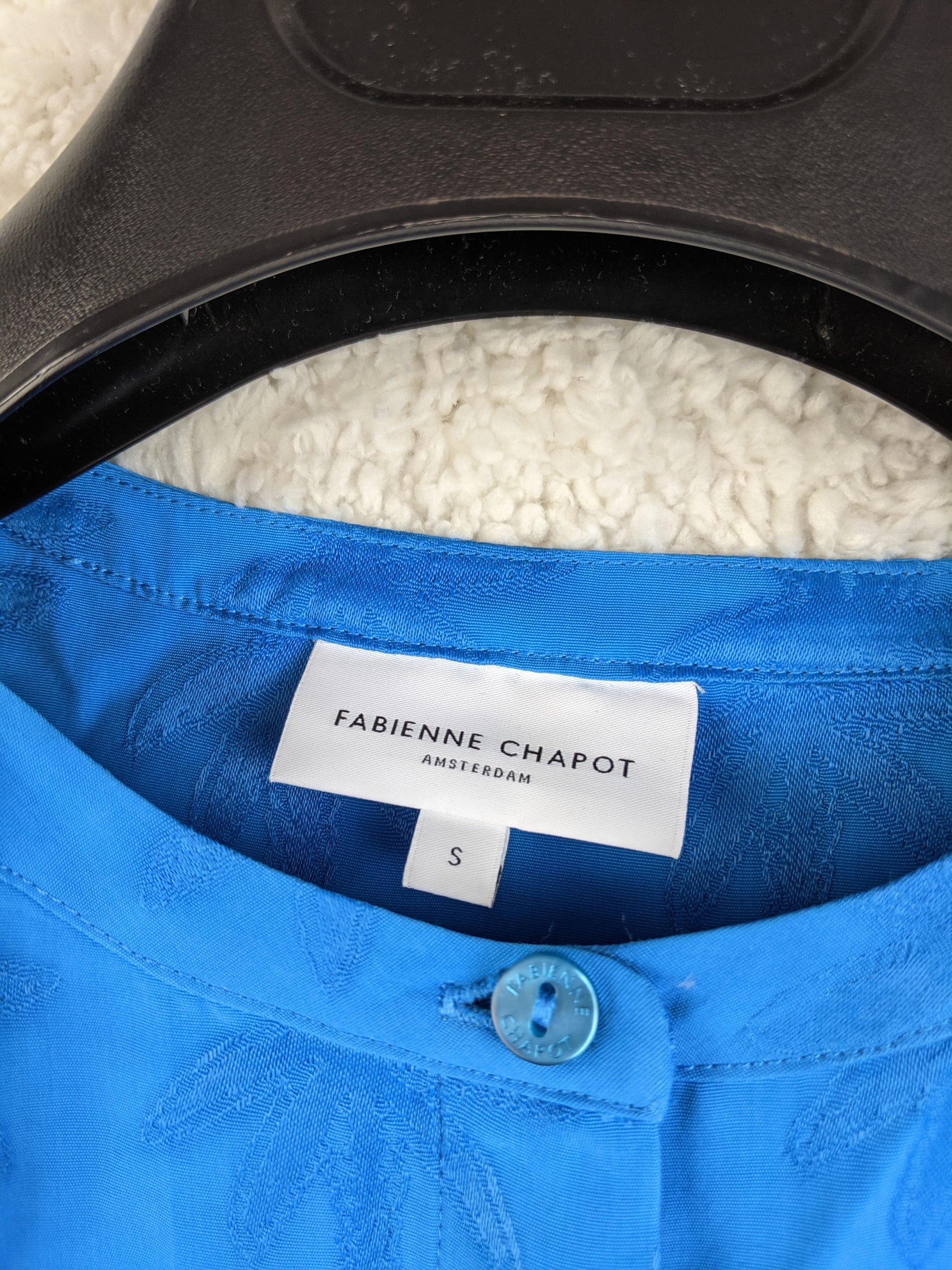 Brand label of Fabienne Chapot on a blue blouse