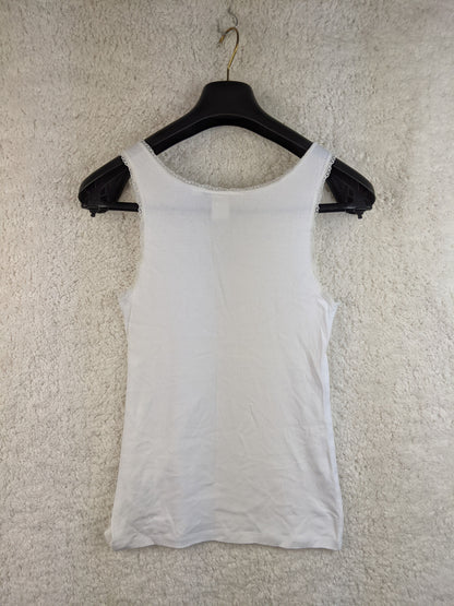Back view of white lace trim tank top on hanger