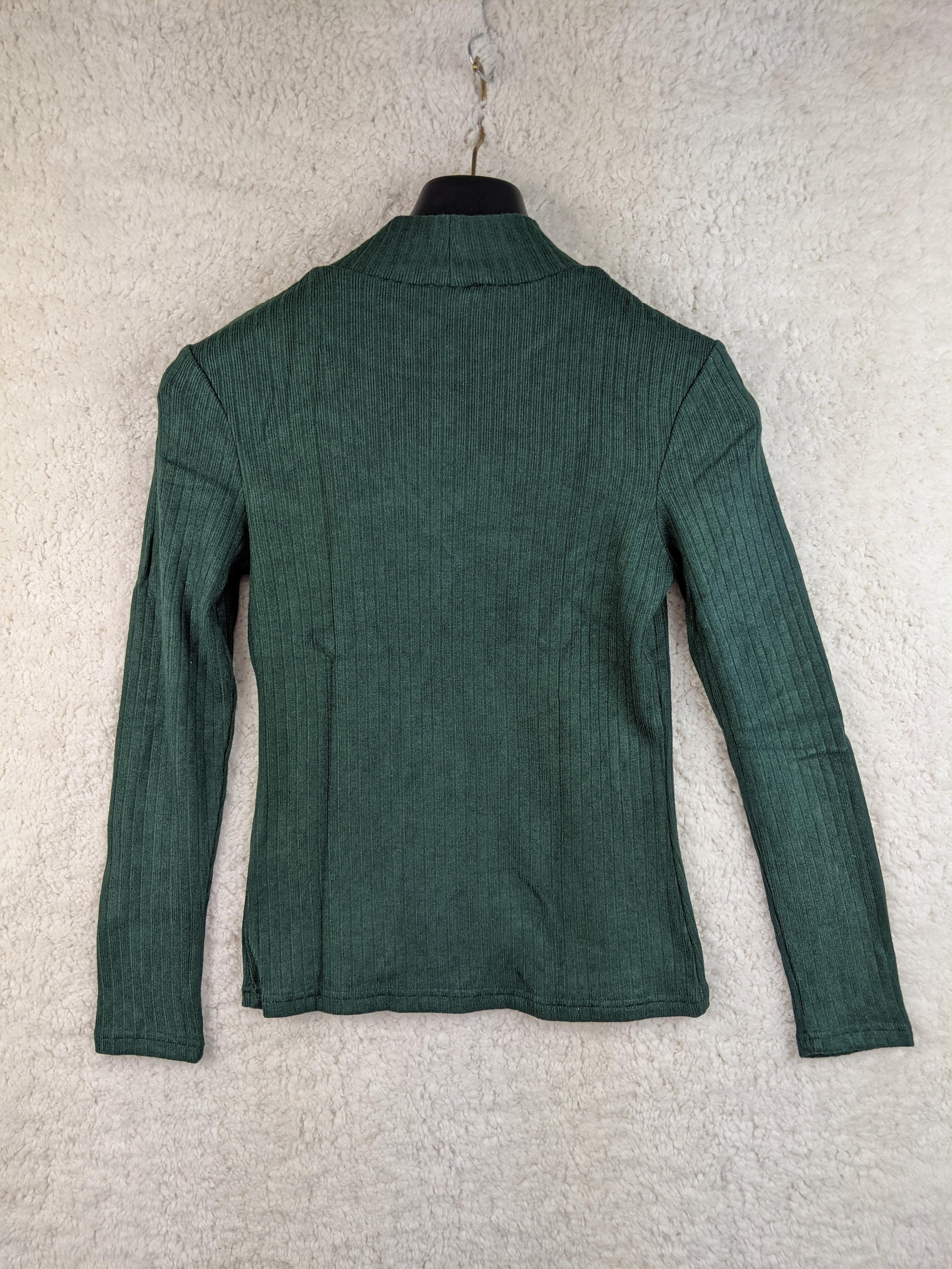 Back view of green ribbed long sleeve top on hanger