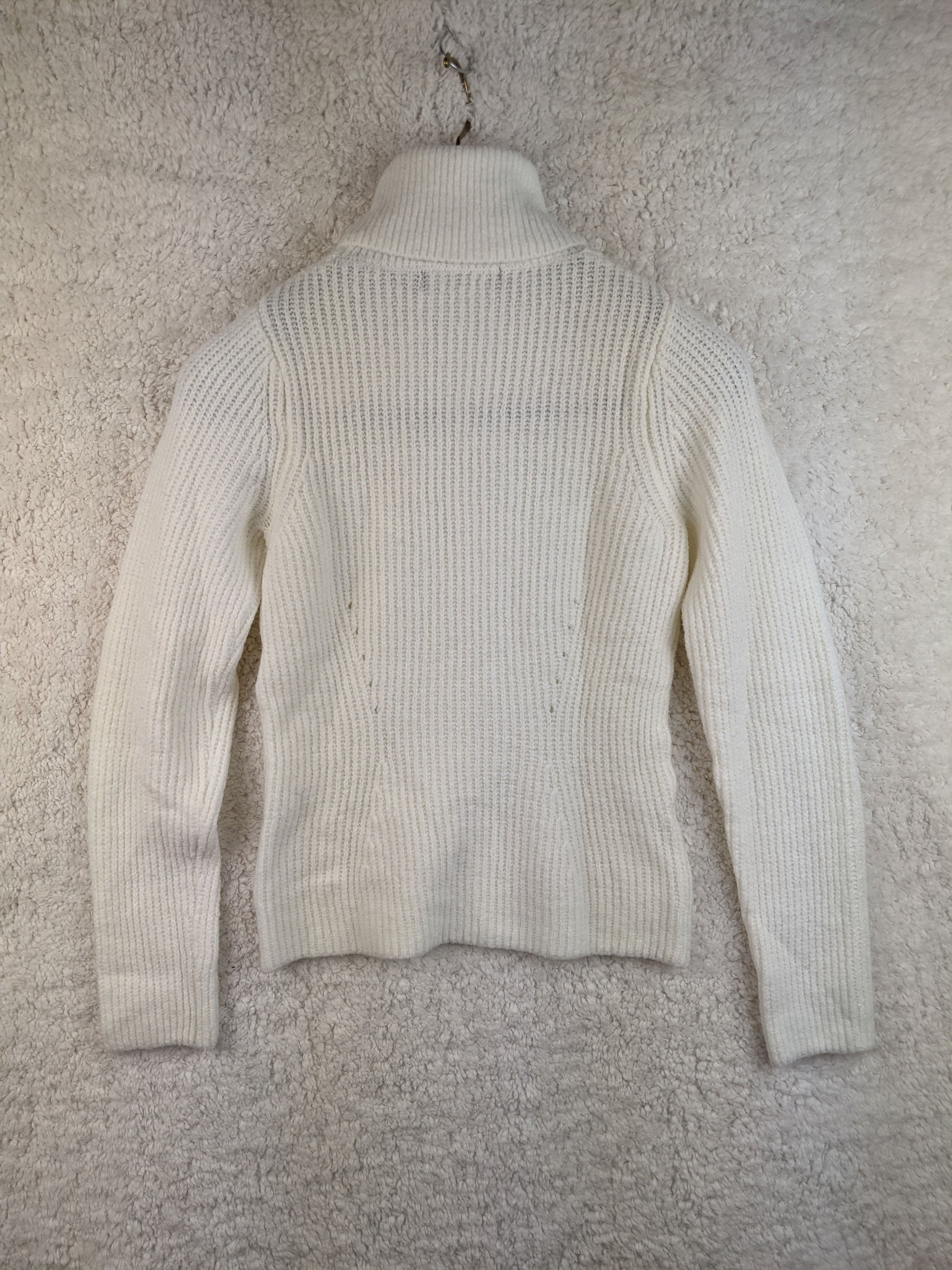 Back view of white ribbed turtleneck sweater