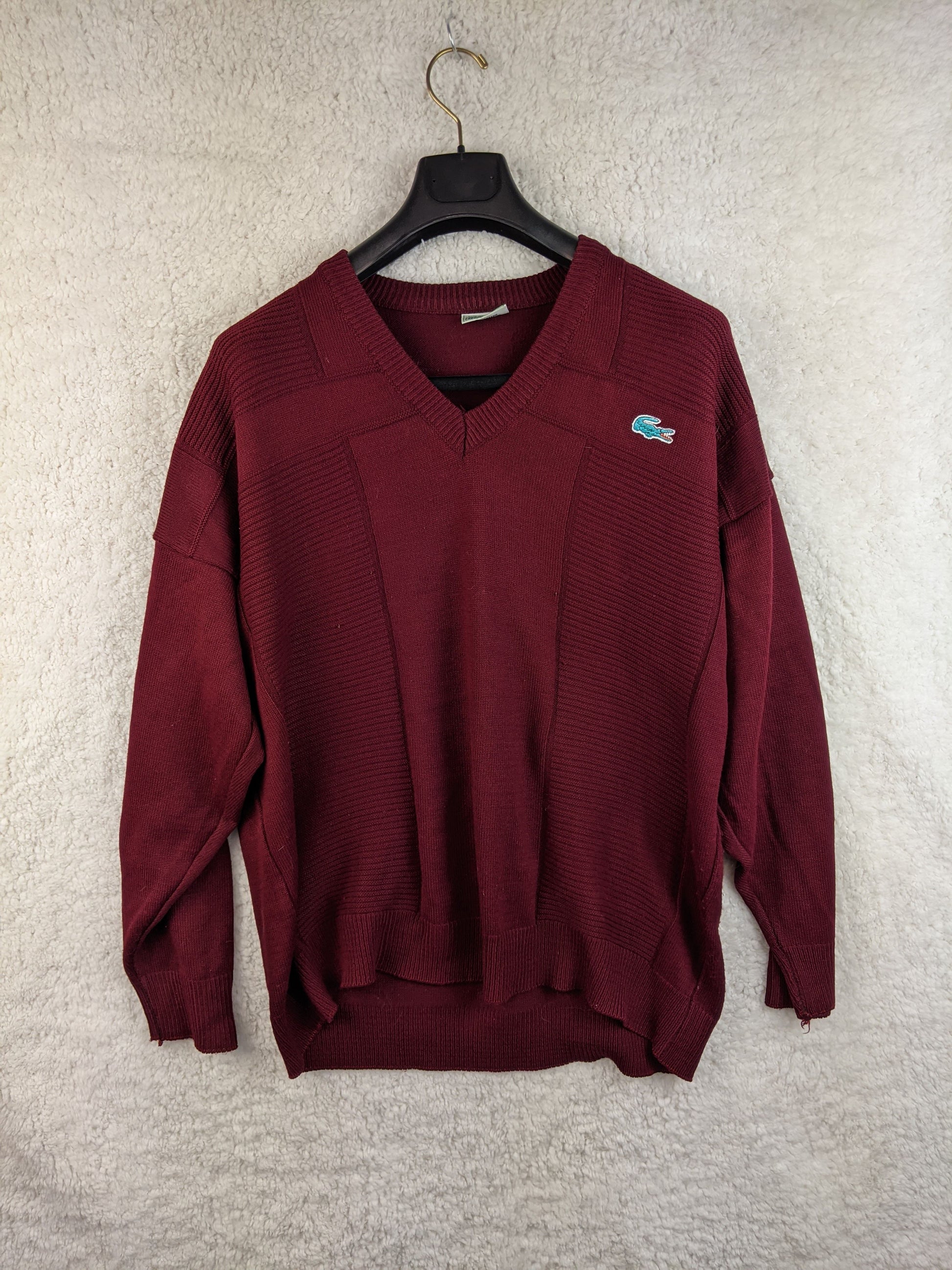 Burgundy V-neck sweater on a hanger