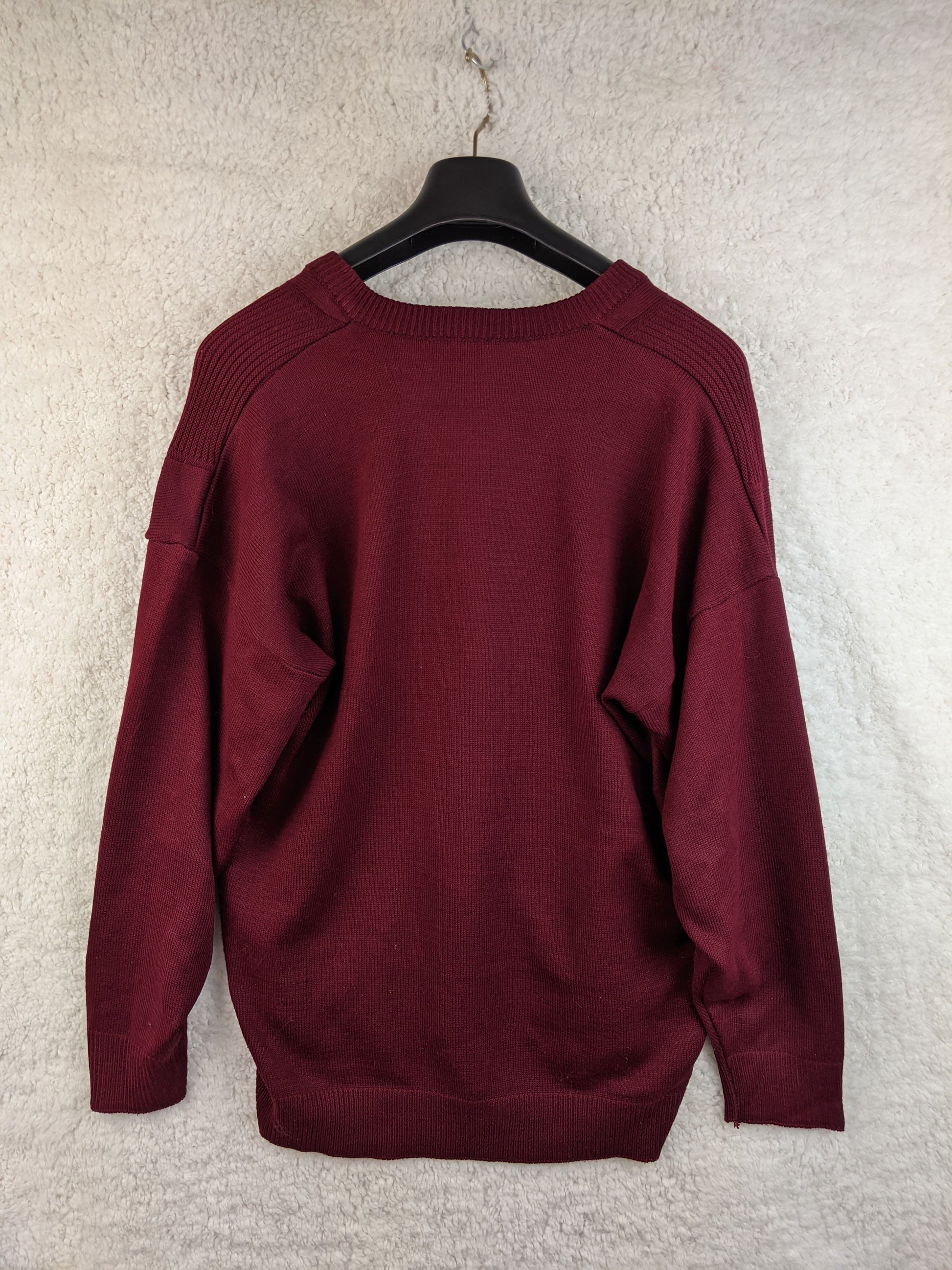 Back view of the burgundy sweater on a hanger