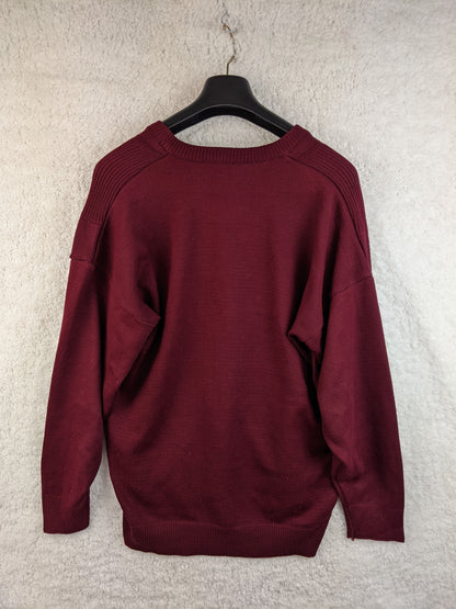 Back view of the burgundy sweater on a hanger