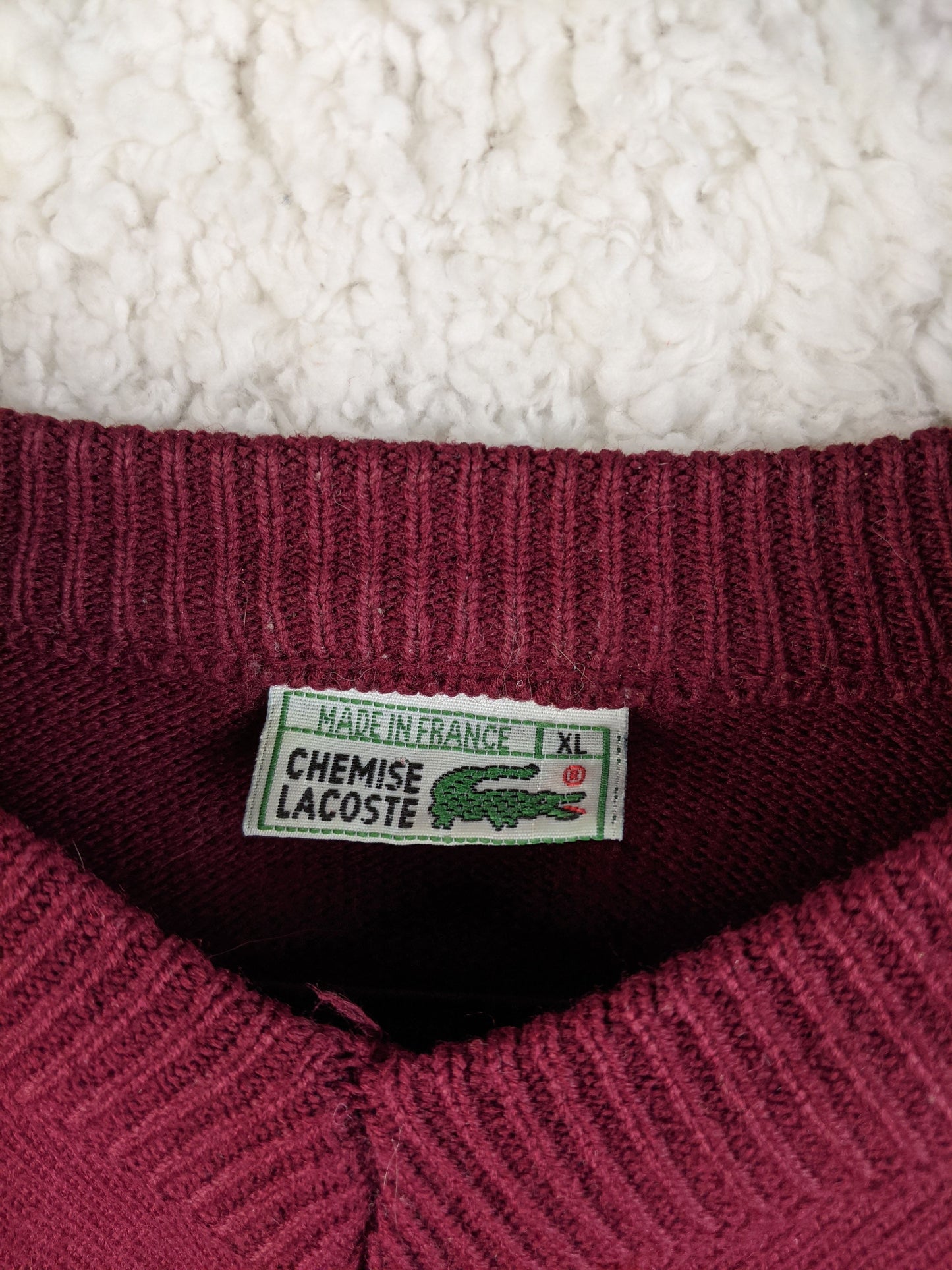 Close-up of Lacoste label on the sweater