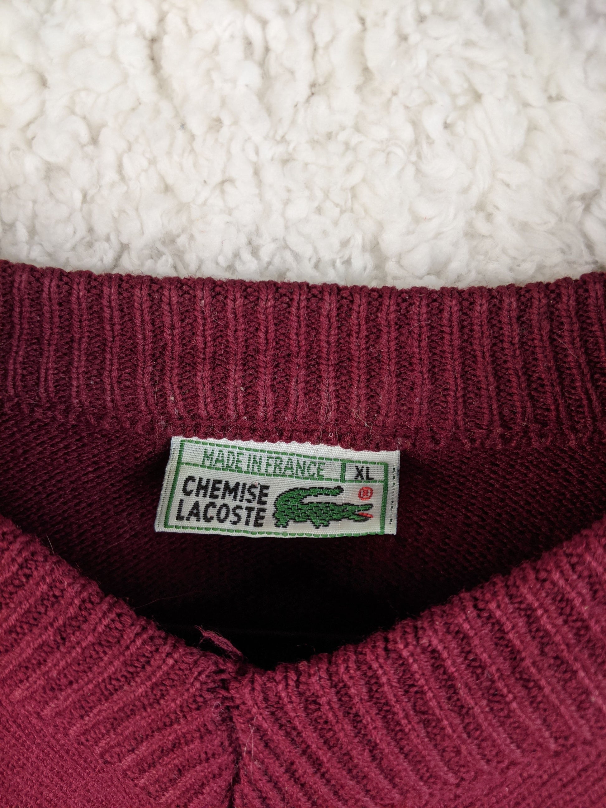 Close-up of Lacoste label on the sweater