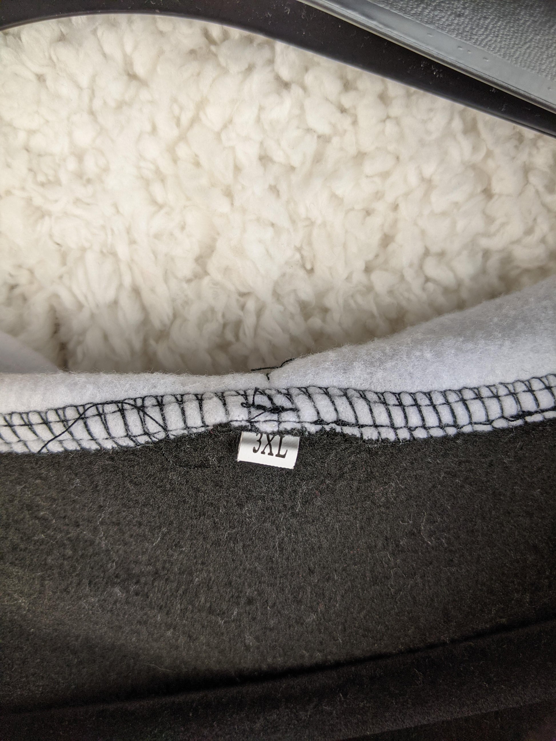 Size label showing 3XL on Lonsdale black hoodie