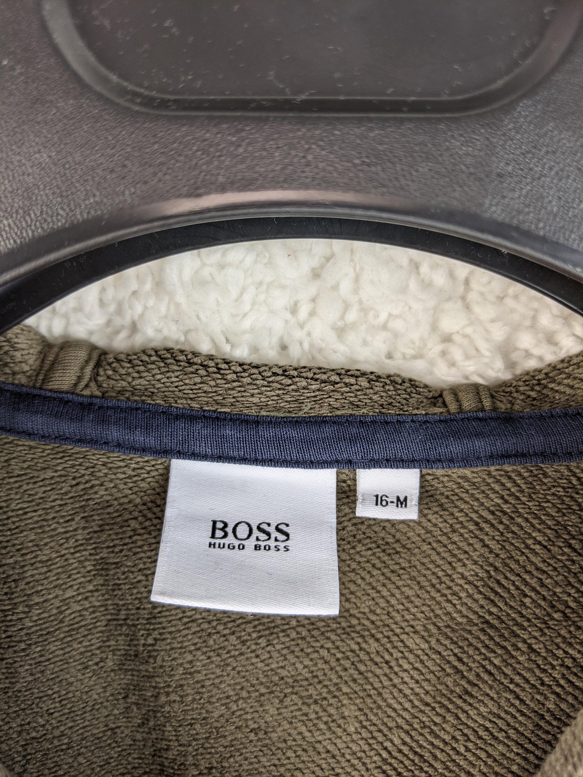 Close-up of Hugo Boss hoodie label indicating size 16 M
