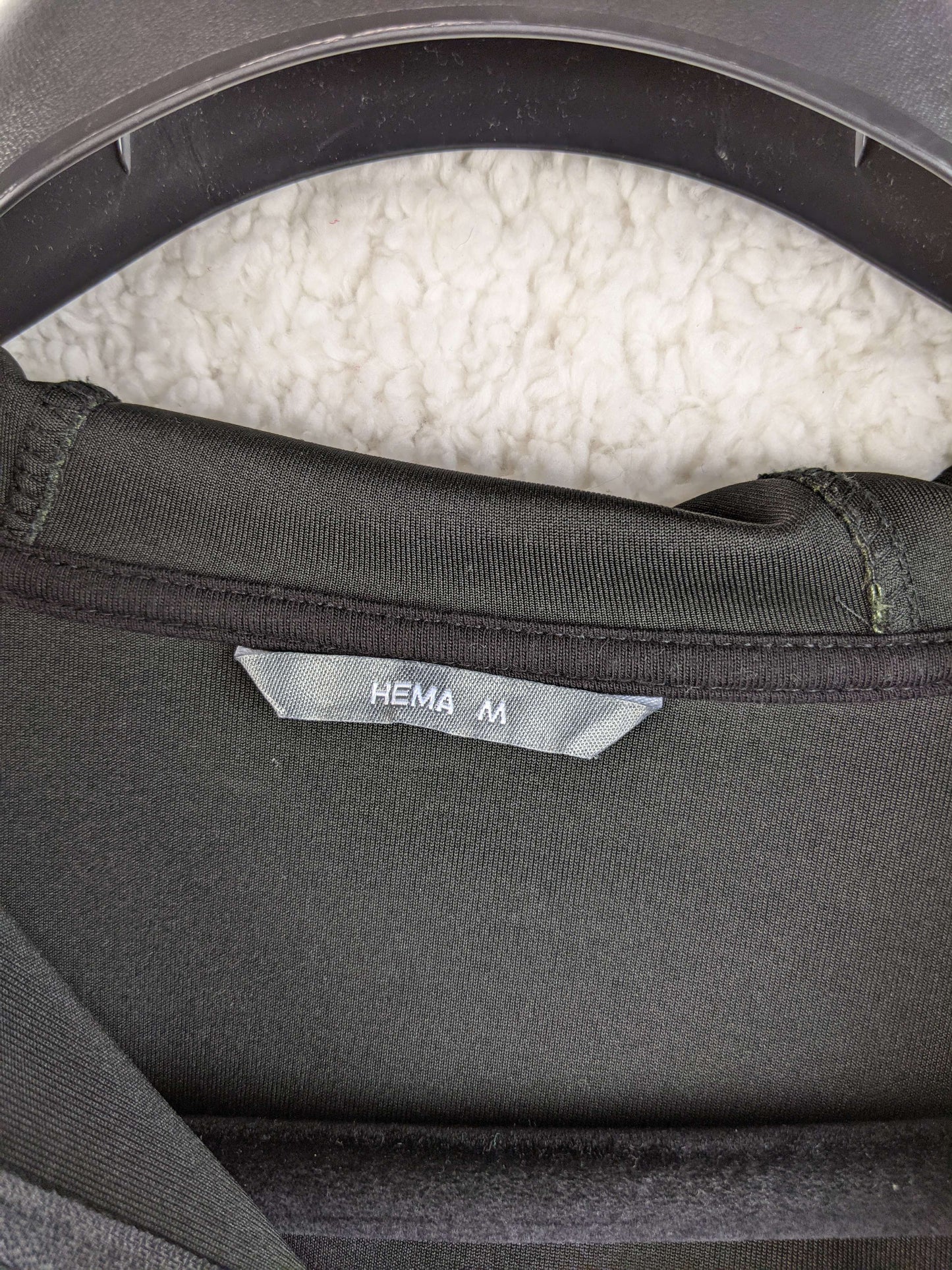 Close-up of the Hema brand label on the hoodie