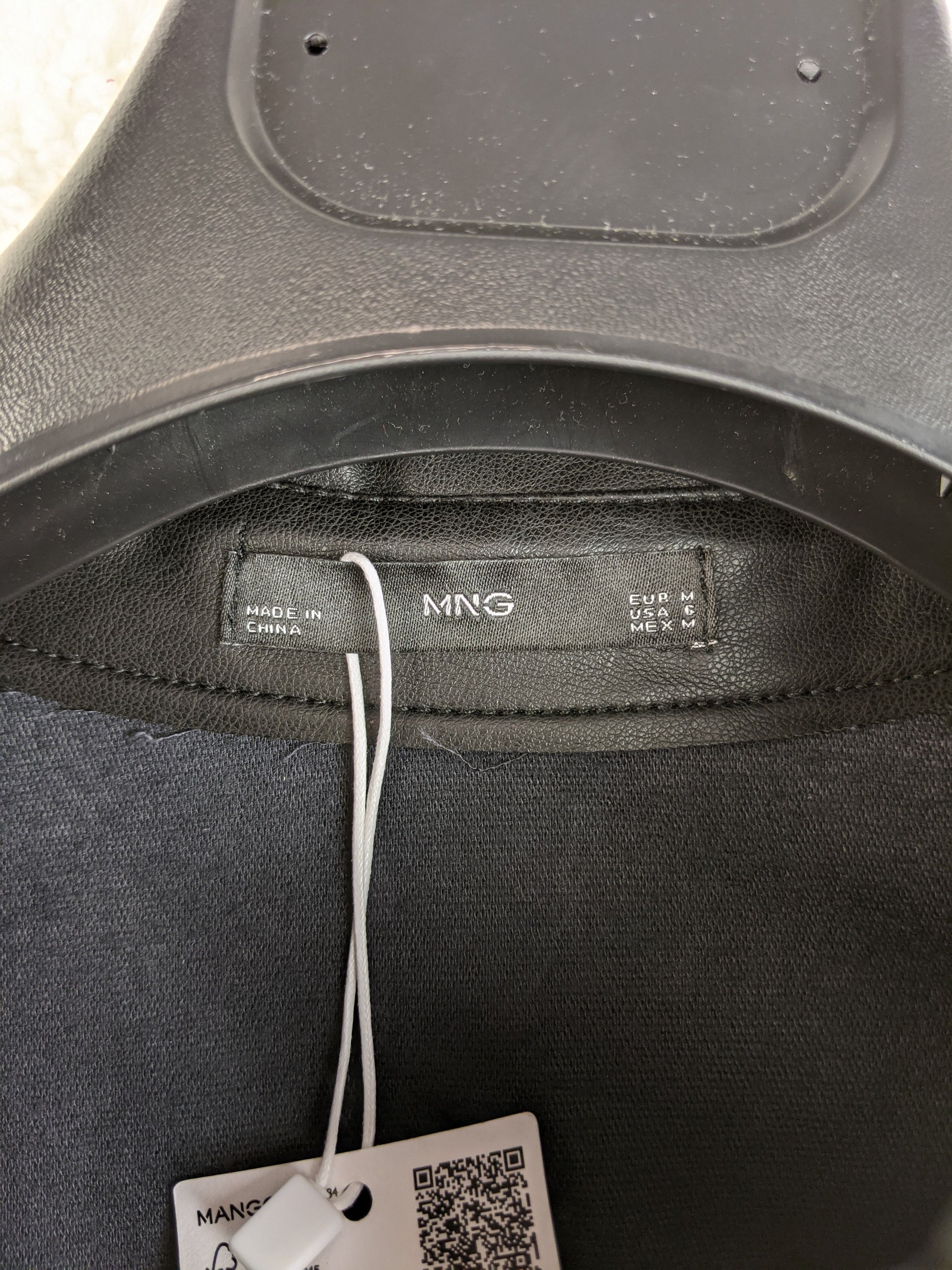 Label of Mango black faux leather shirt showing size M